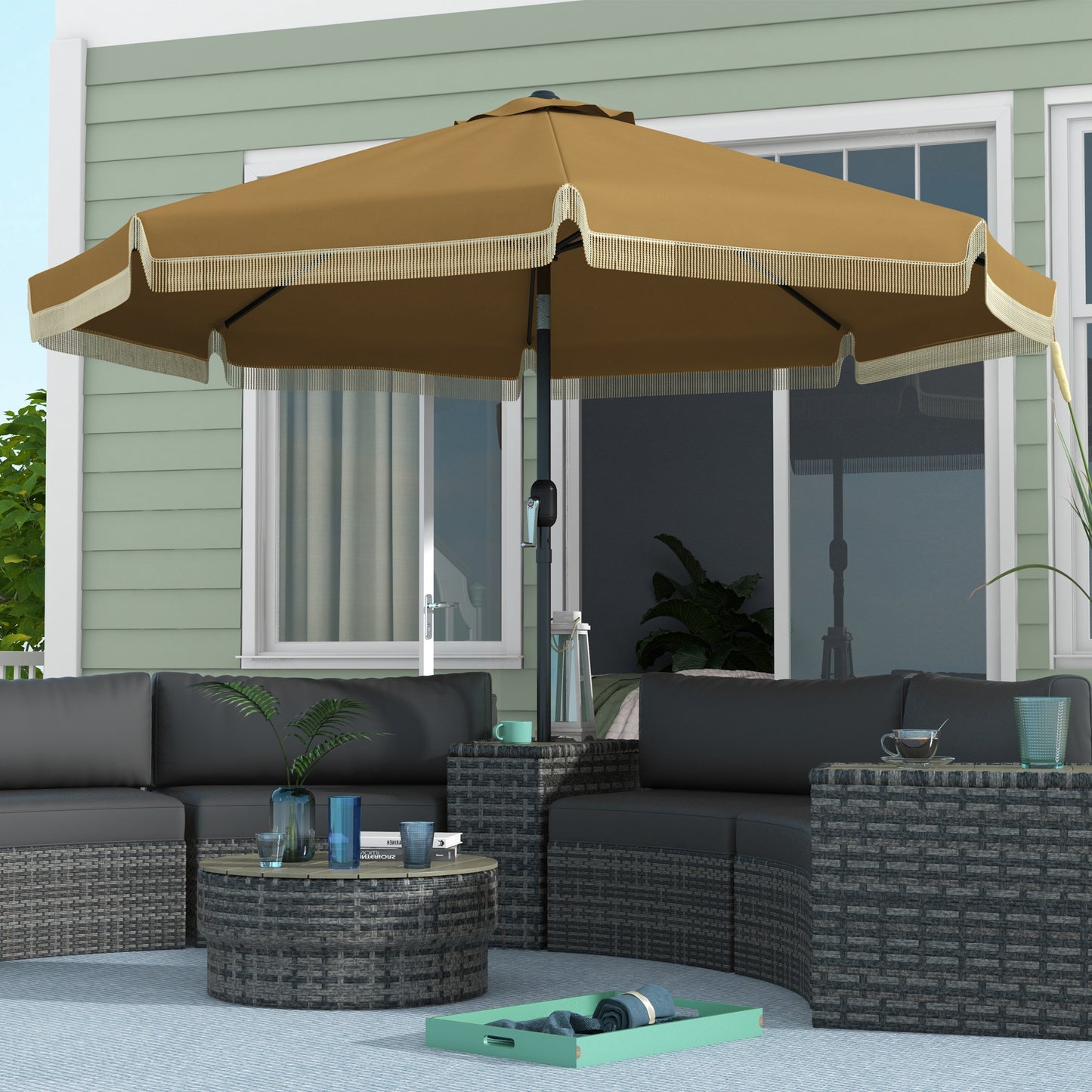 Bronze patio umbrella with decorative fringe providing shade over sectional furniture