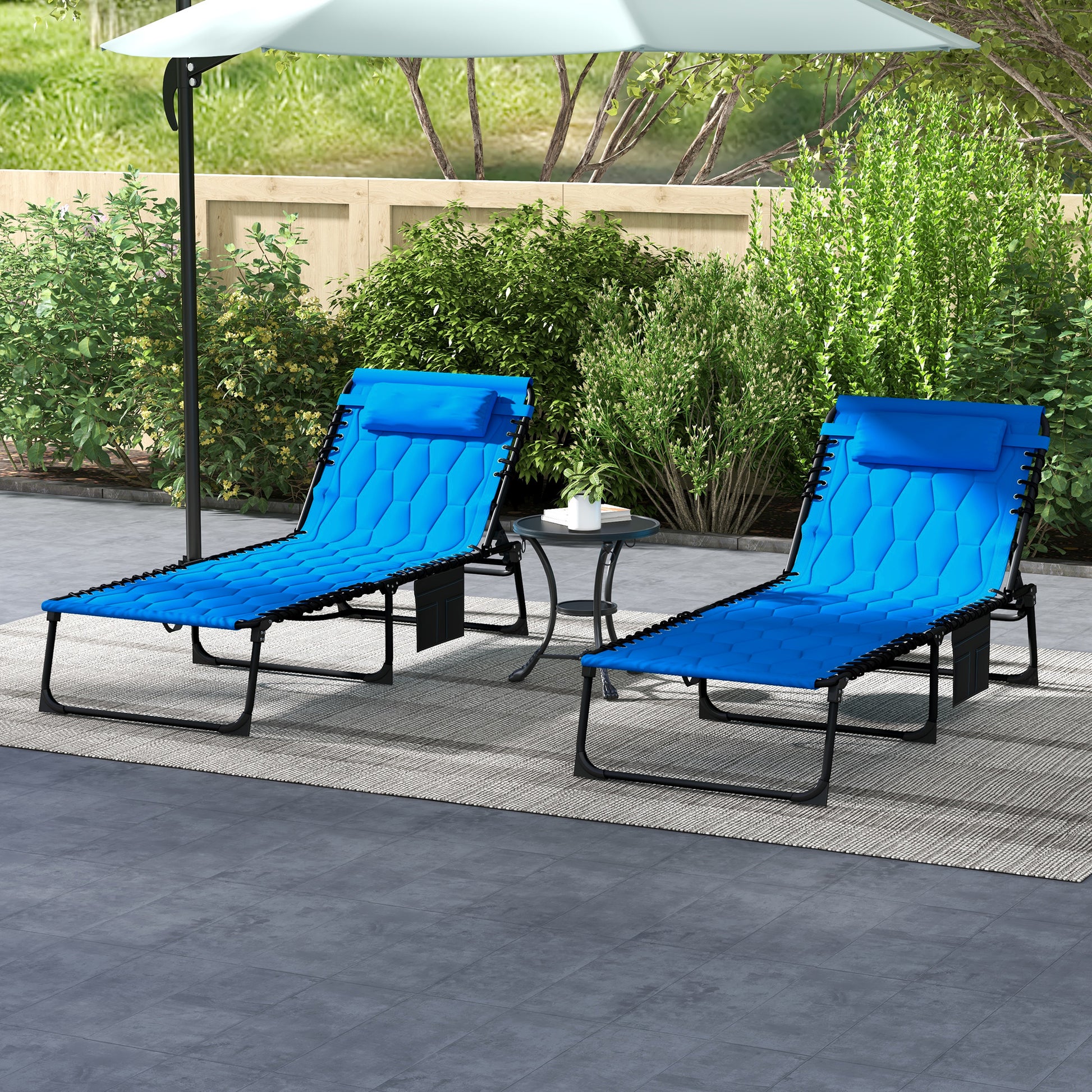 Two blue zero gravity chairs with adjustable headrests on a patio rug
