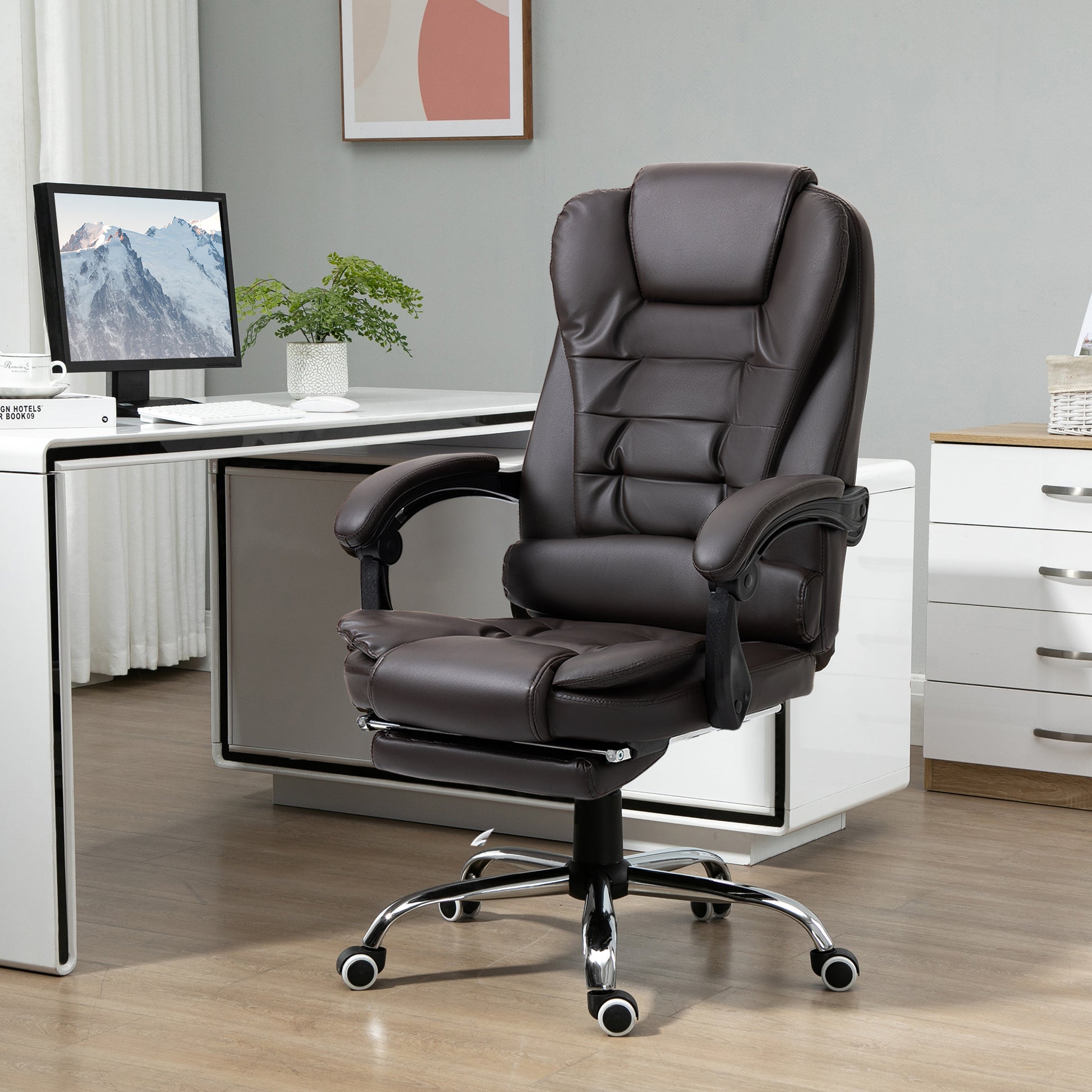 Plush brown executive office chair with padded armrests and a retractable footrest