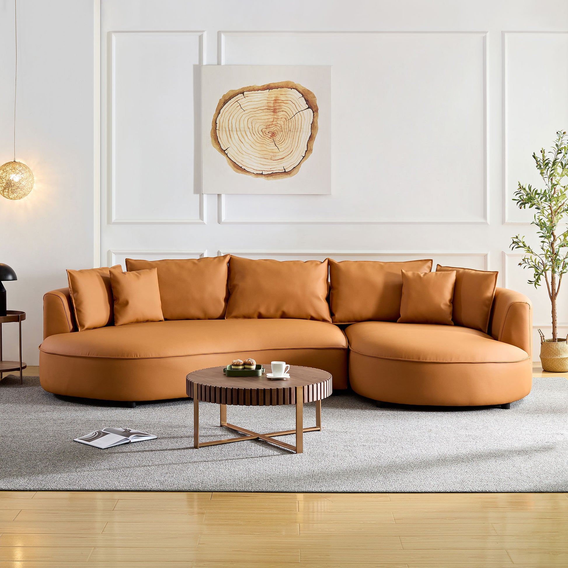 Spacious caramel leather sectional sofa with plush throw pillows perfect for modern living rooms