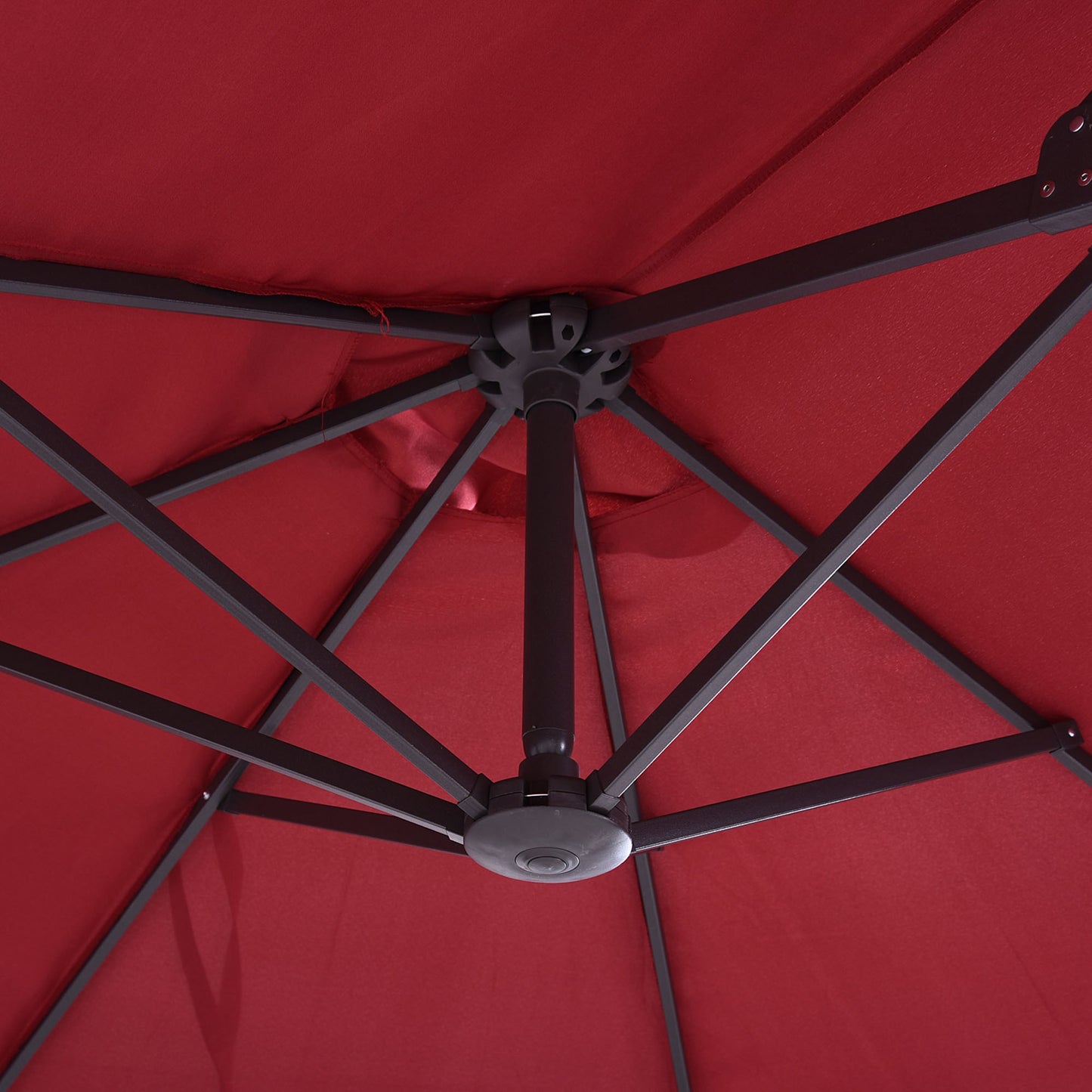Red patio umbrella canopy interior with dark gray metal frame and central hub