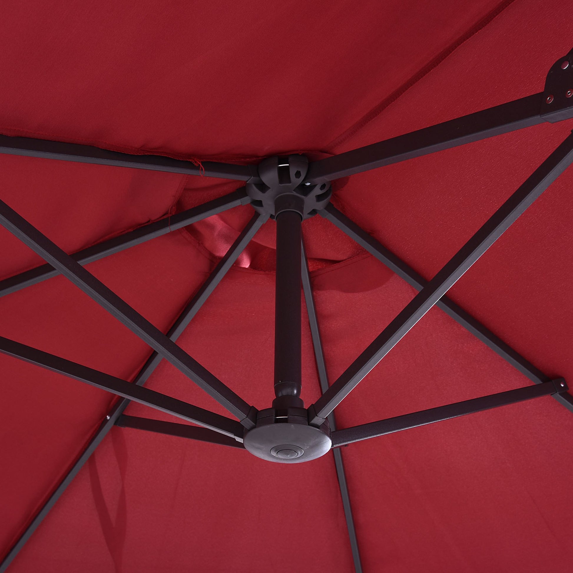 Red patio umbrella canopy interior with dark gray metal frame and central hub