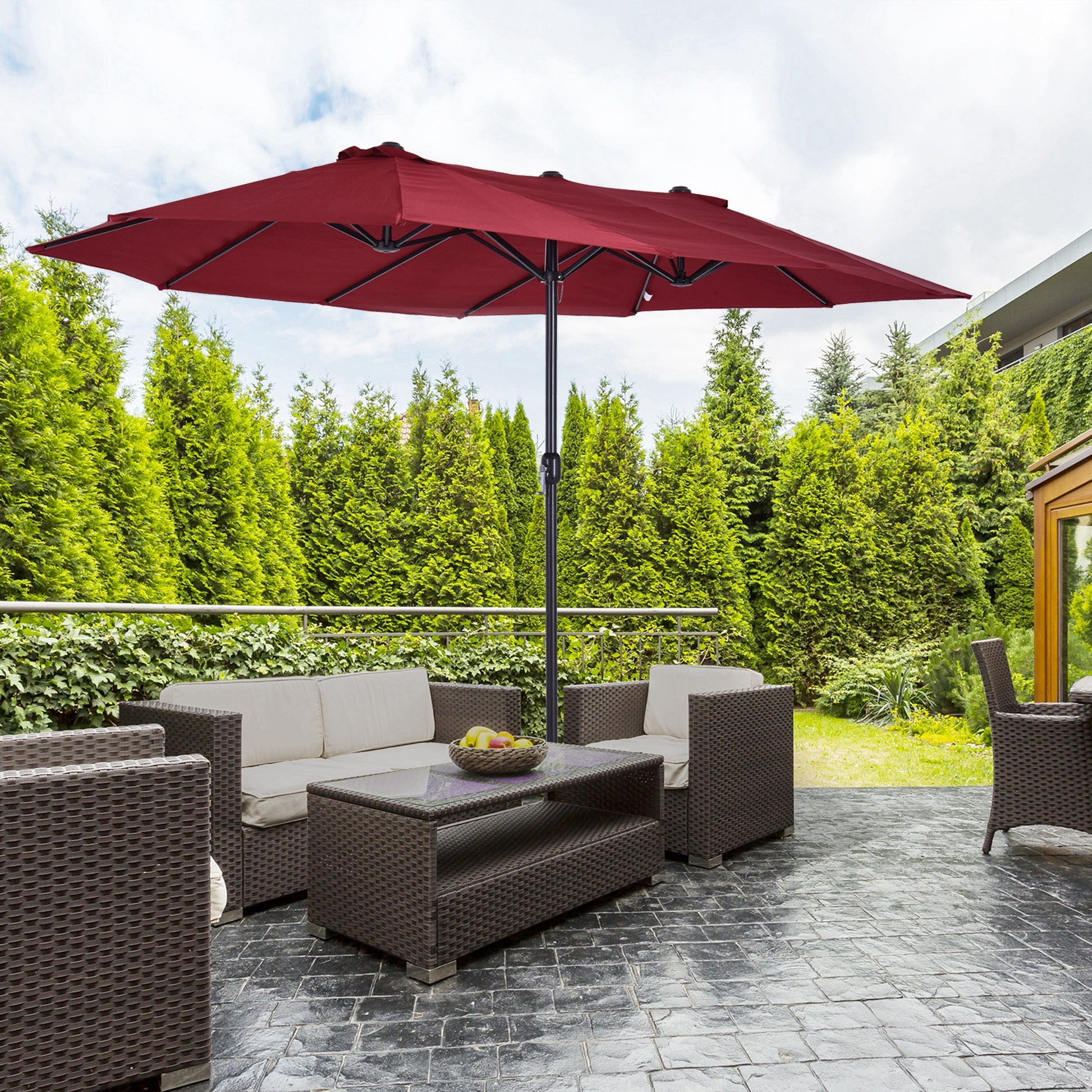Large red double patio umbrella providing shade over outdoor furniture