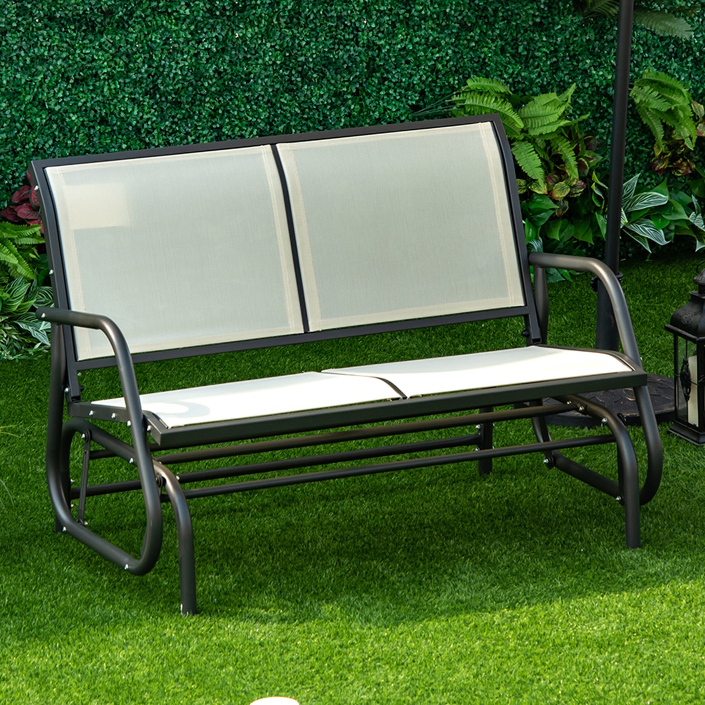 Black metal frame patio glider with white mesh seat and backrest