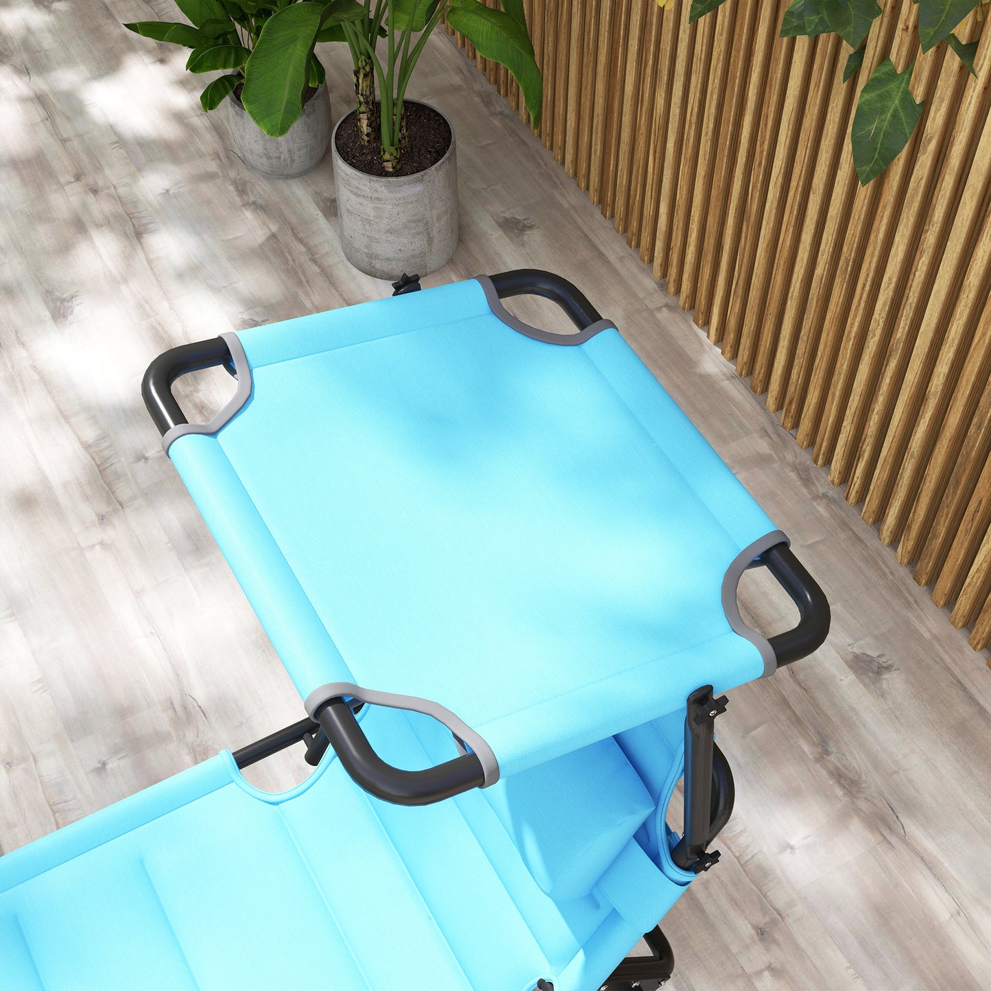 Light blue portable camping chair with black frame and grey accents on wooden deck