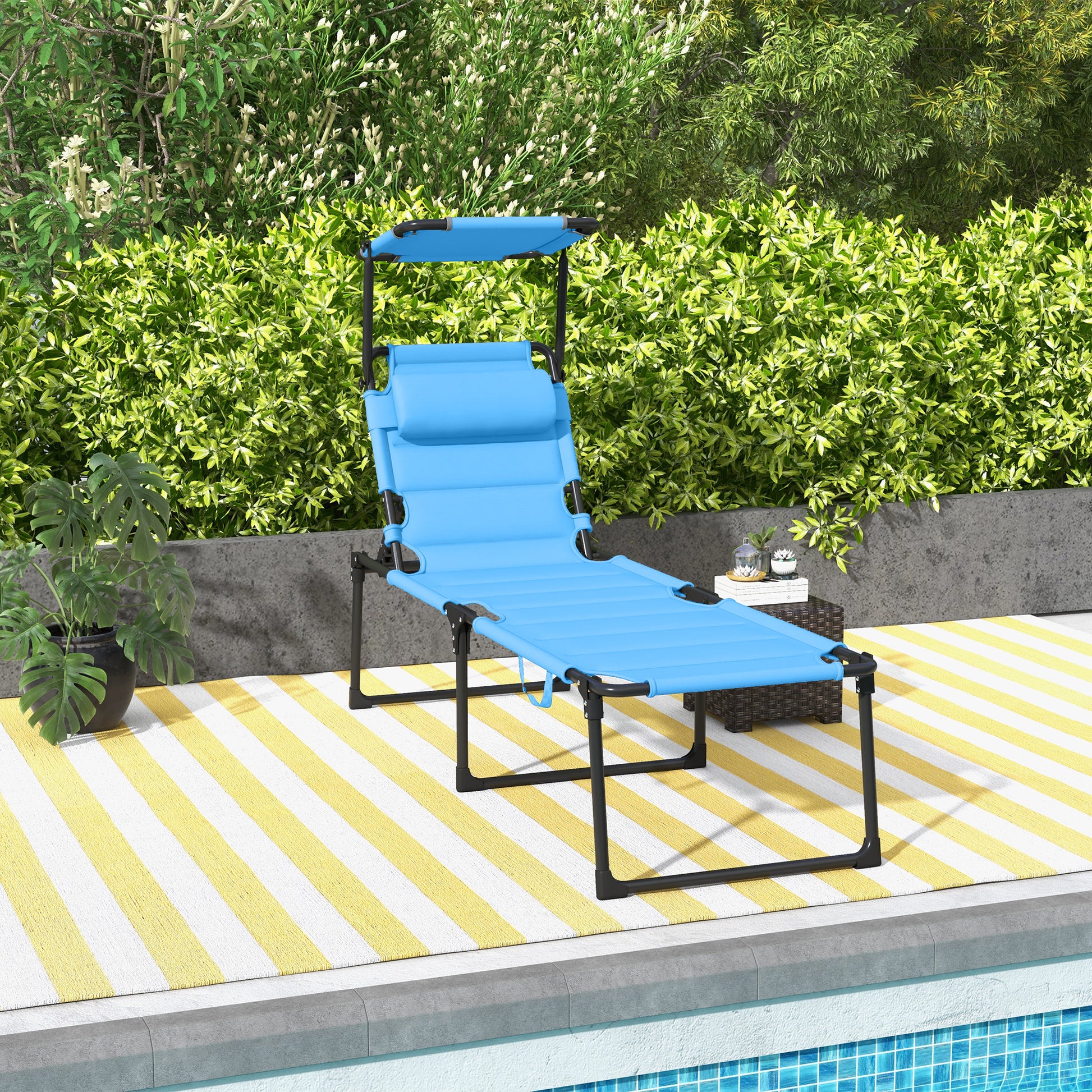 Blue adjustable chaise lounge with canopy on yellow striped rug near pool