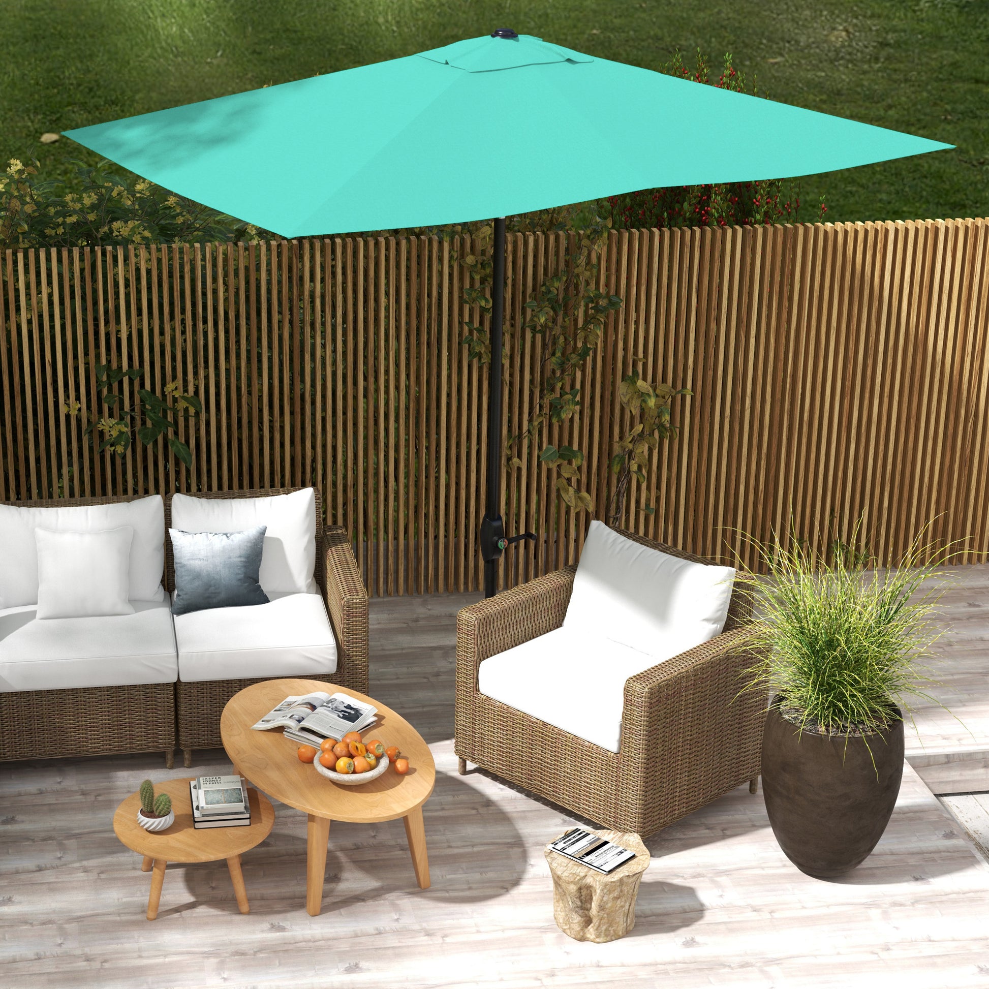 Rectangular teal patio umbrella providing shade for rattan sofa and armchair set