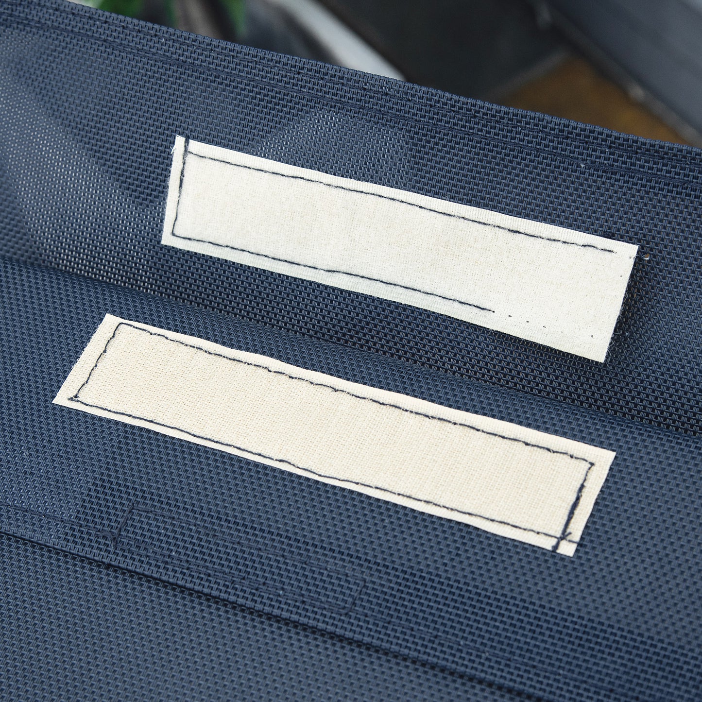 Dark blue fabric with two beige rectangular patches likely for customization