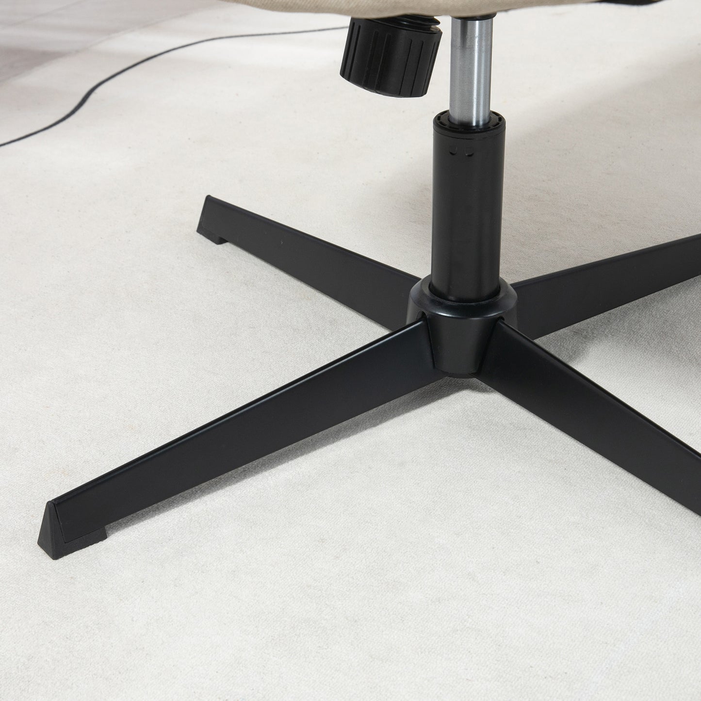 Black metal office chair base with five legs on a light carpet