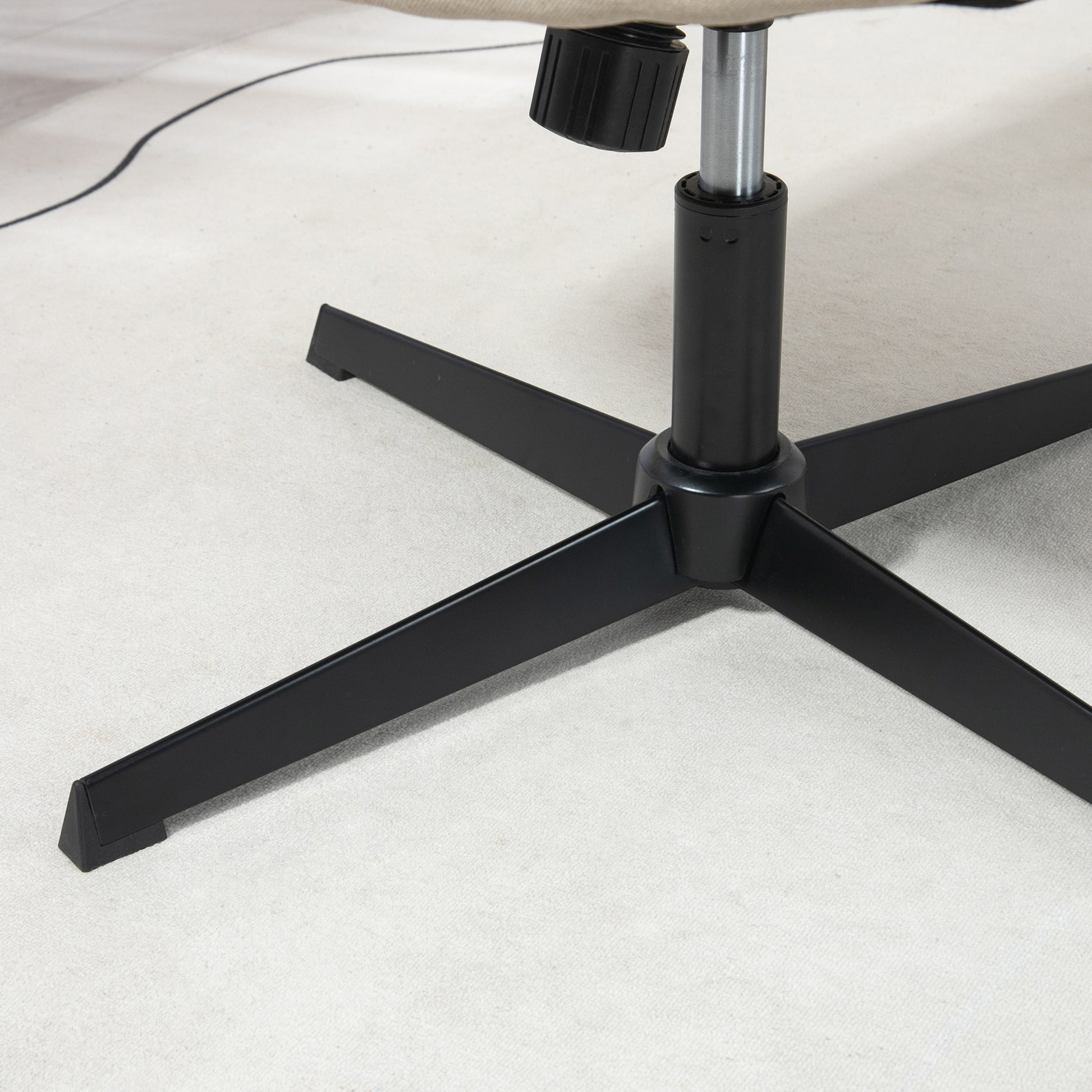 Black metal office chair base with five legs on a light carpet