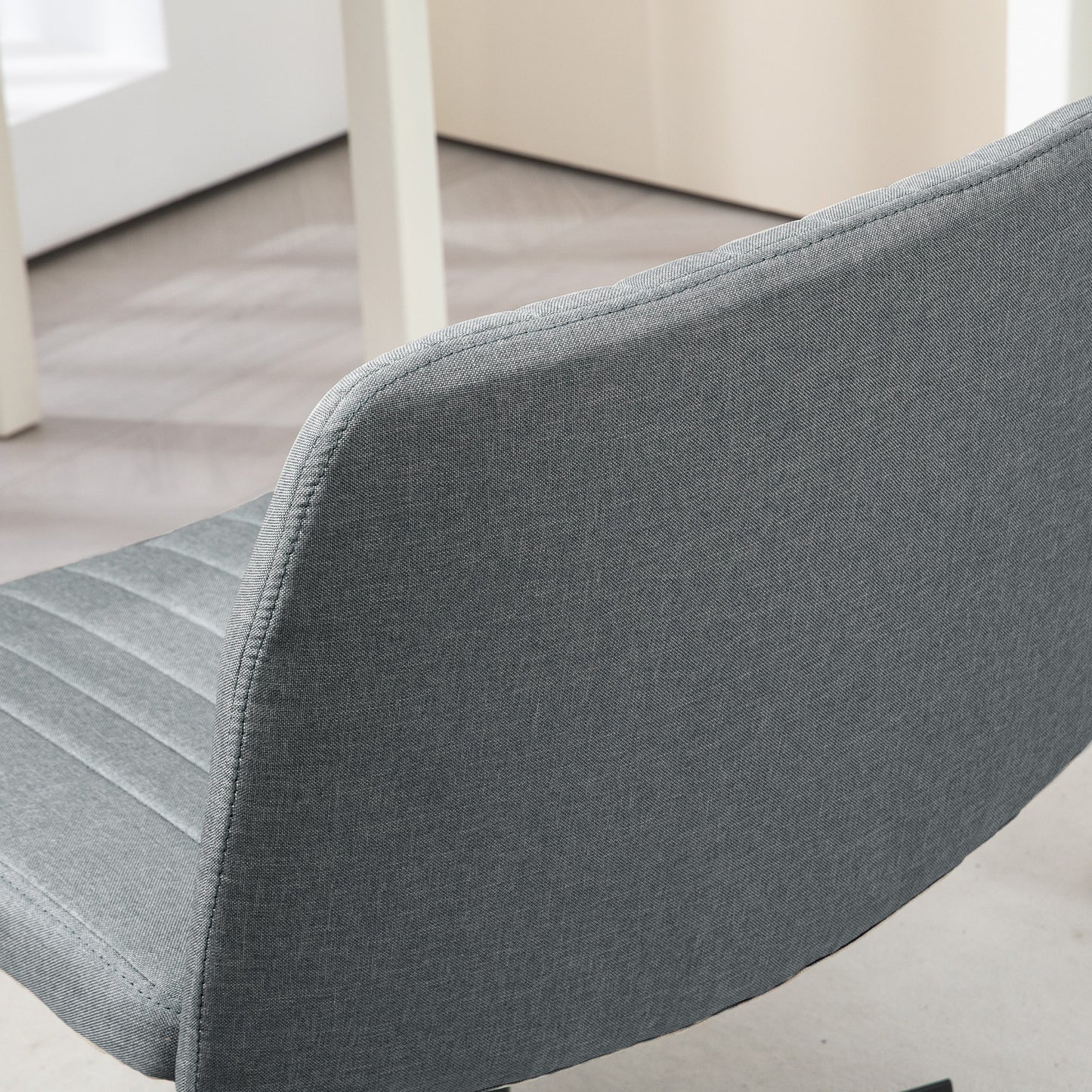 Dark gray upholstered dining chair back with subtle ribbed detail