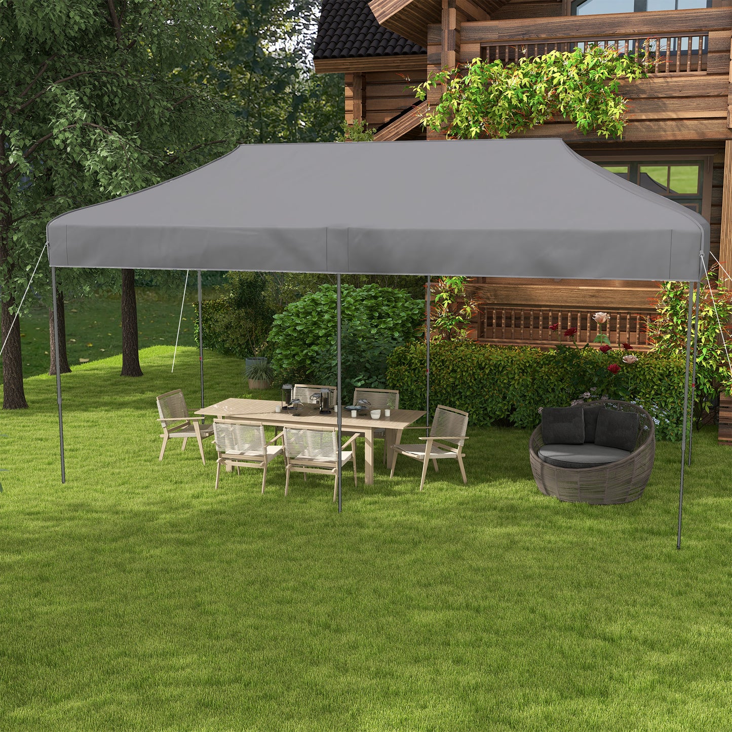 Gray outdoor canopy tent providing shade for a patio dining set and chair