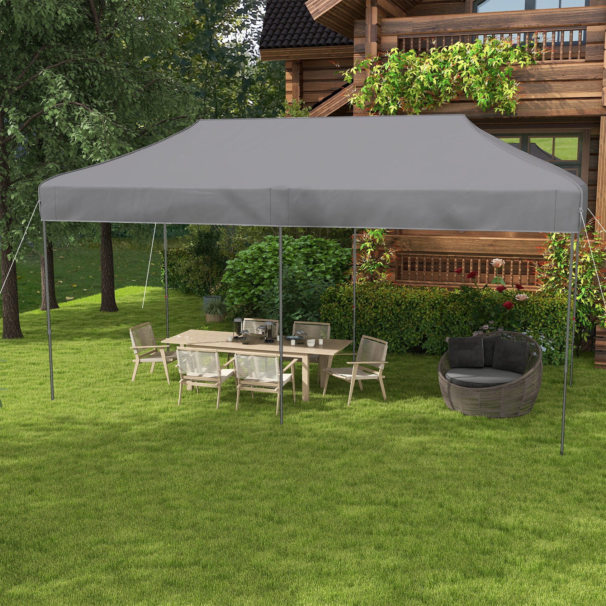 Gray outdoor canopy tent providing shade for a patio dining set and chair