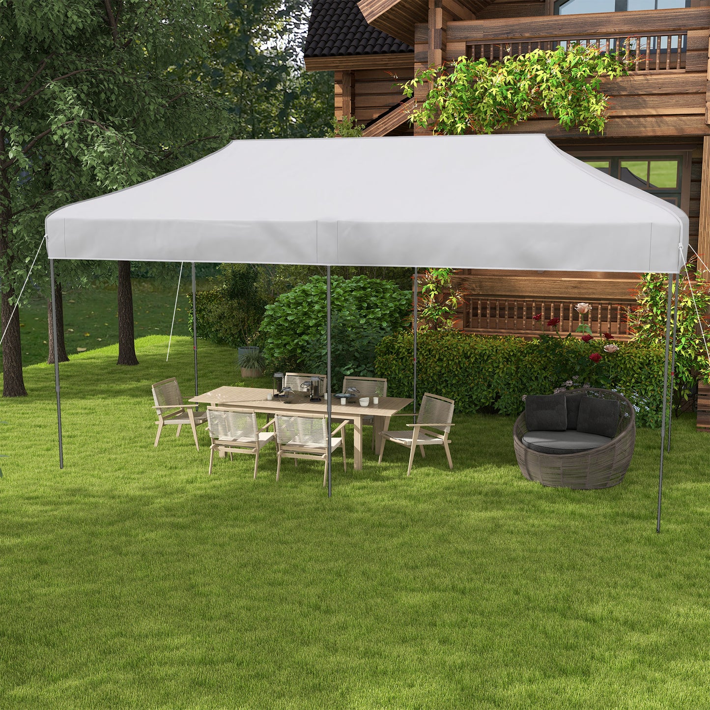 White outdoor canopy tent providing shade for a patio dining set on a grassy lawn