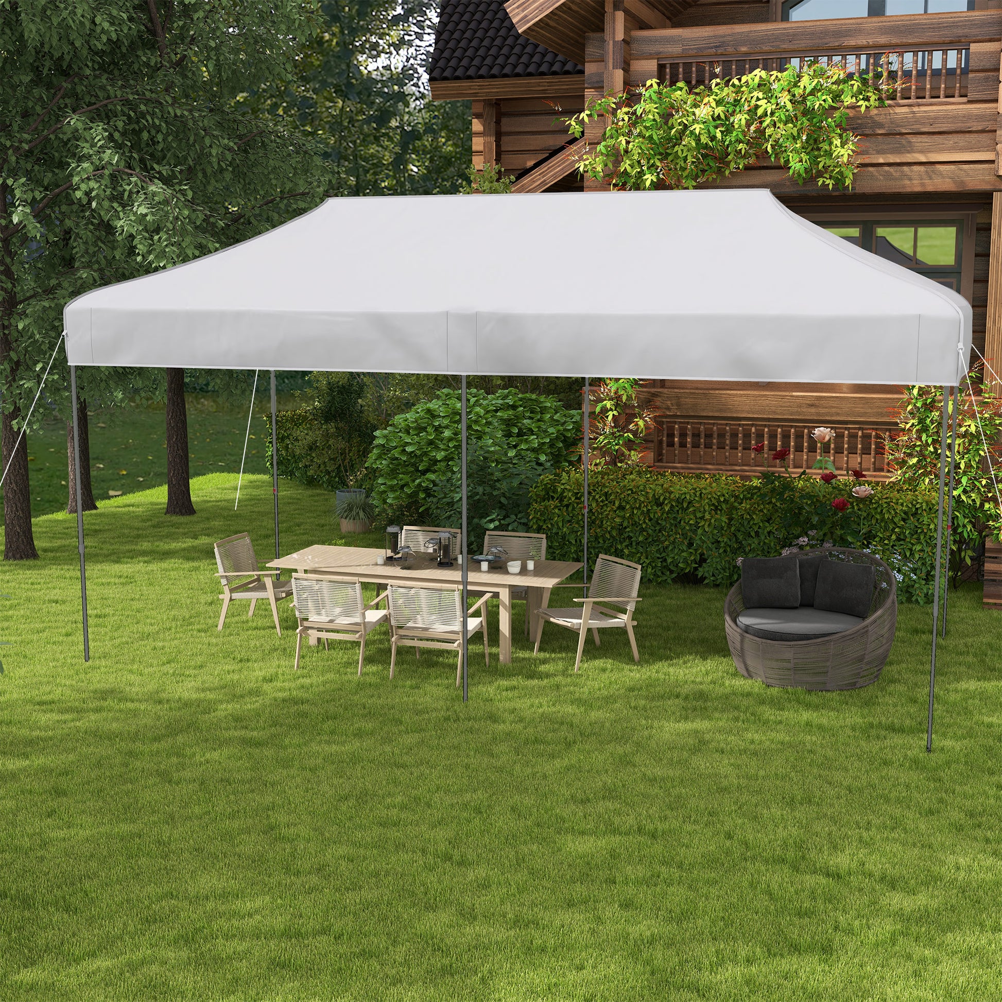 White outdoor canopy tent providing shade for a patio dining set on a grassy lawn