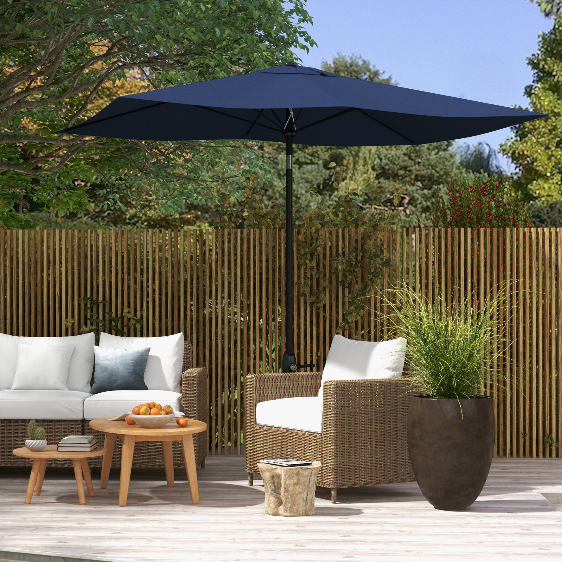 Navy blue patio umbrella providing shade for outdoor wicker furniture on a wooden deck