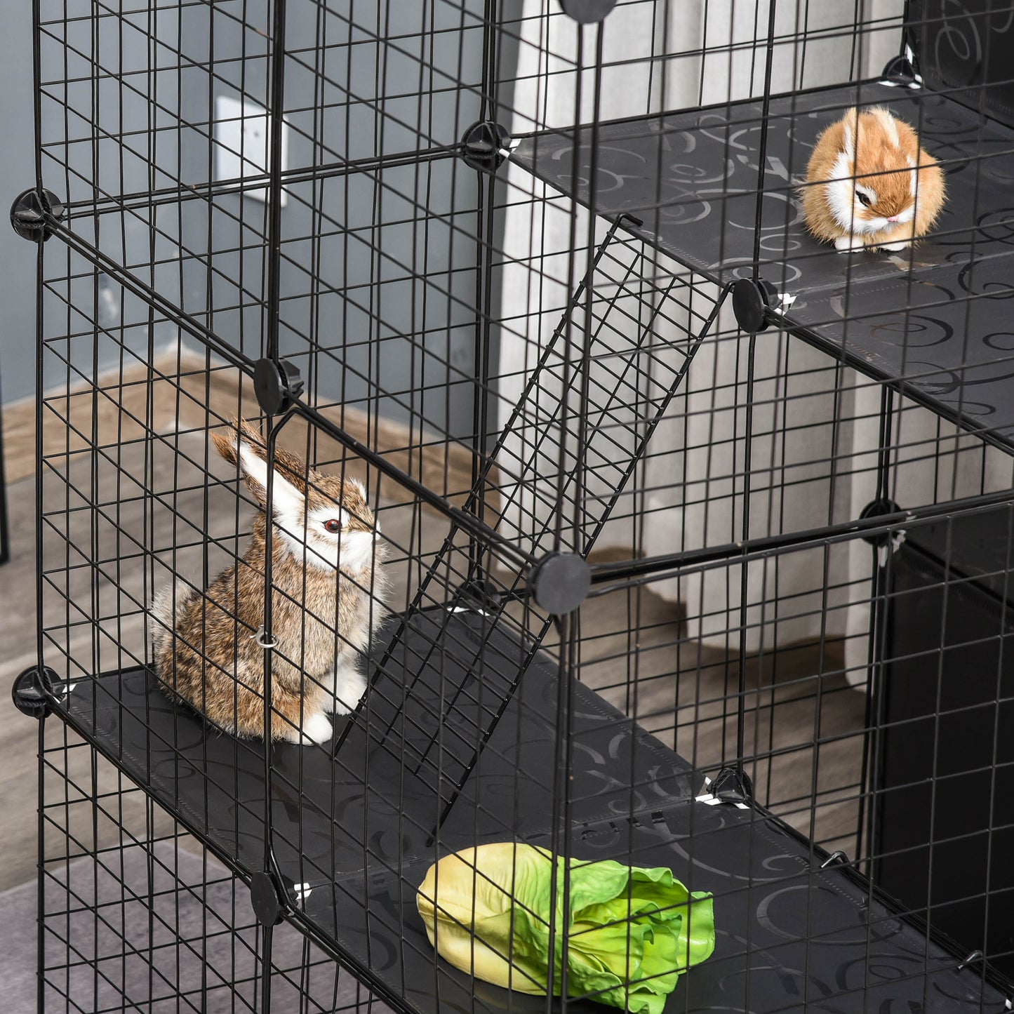 Black wire modular pet playpen with two rabbits and lettuce