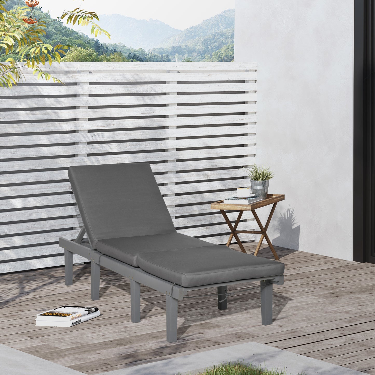 Gray outdoor chaise lounge with thick cushion on wooden deck