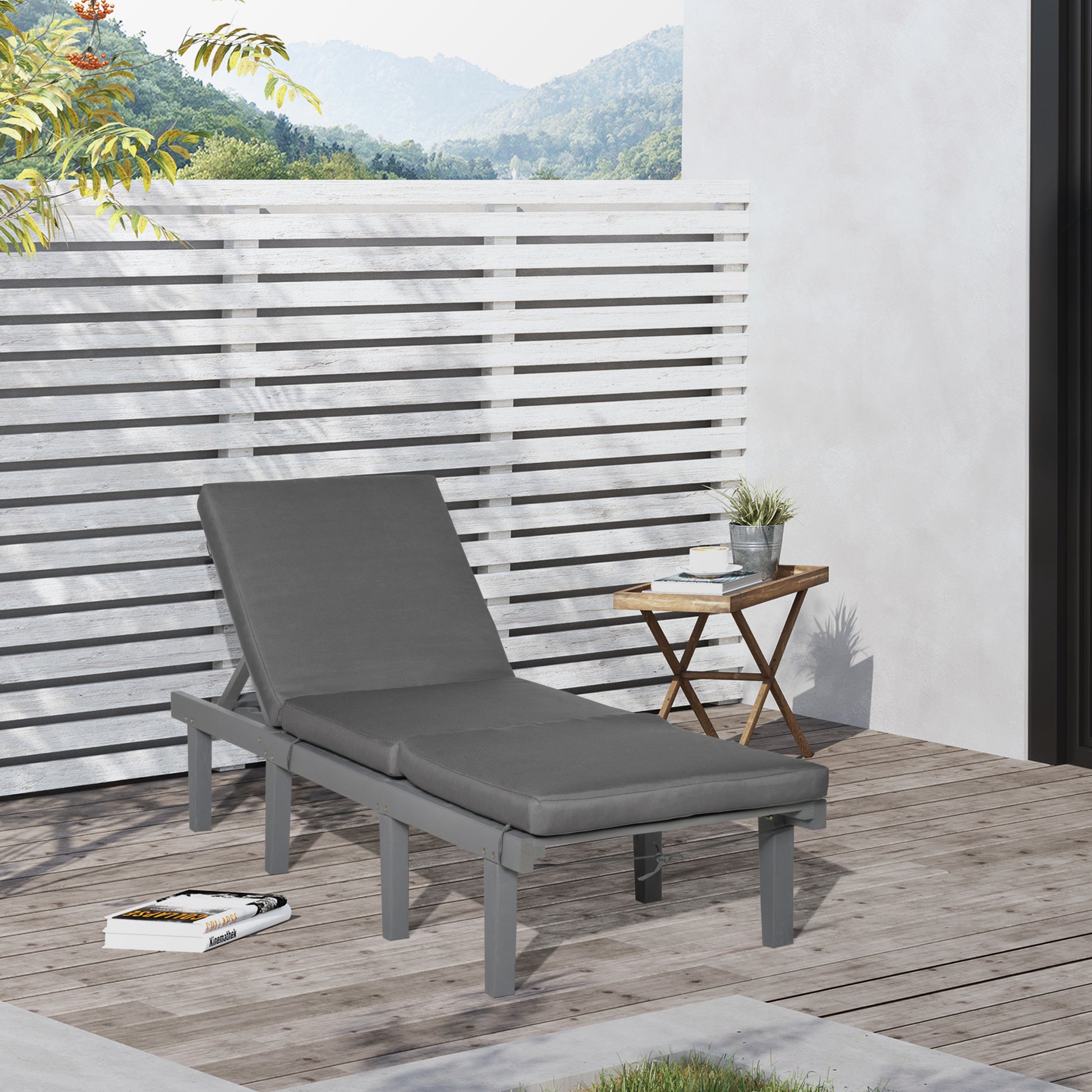 Gray outdoor chaise lounge with thick cushion on wooden deck