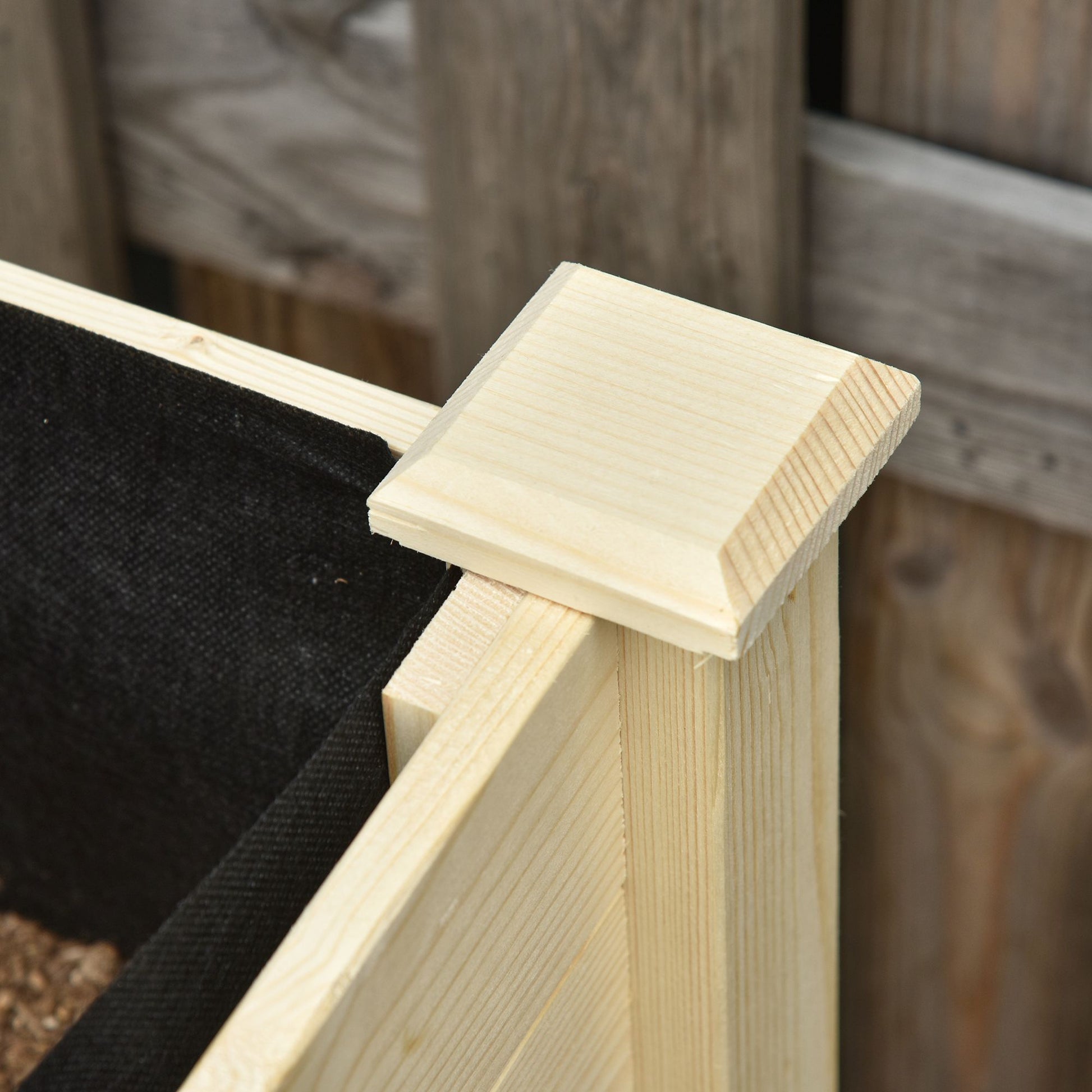 Corner cap detail on unfinished pine raised garden bed kit