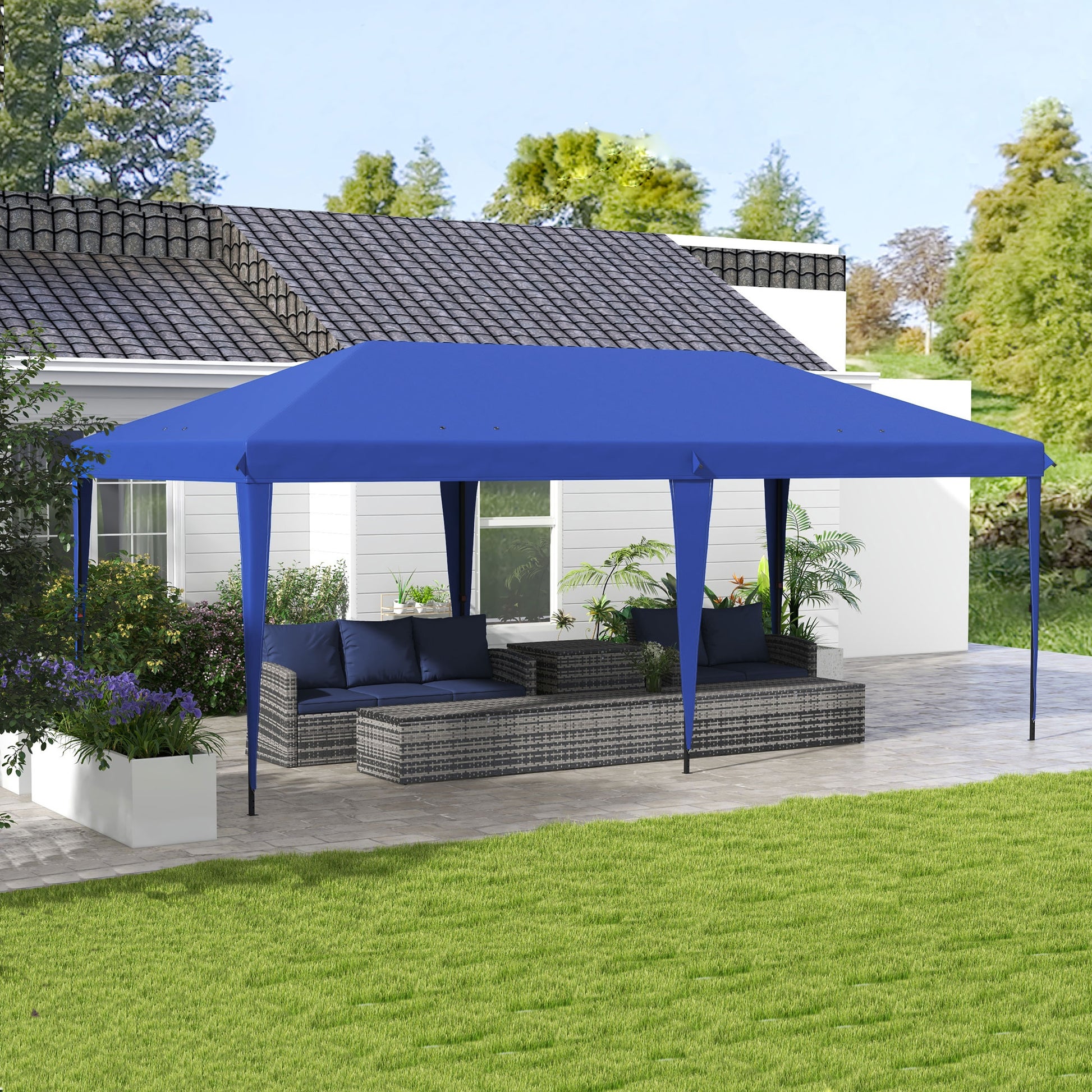 Blue outdoor canopy tent protecting rattan patio furniture from sun