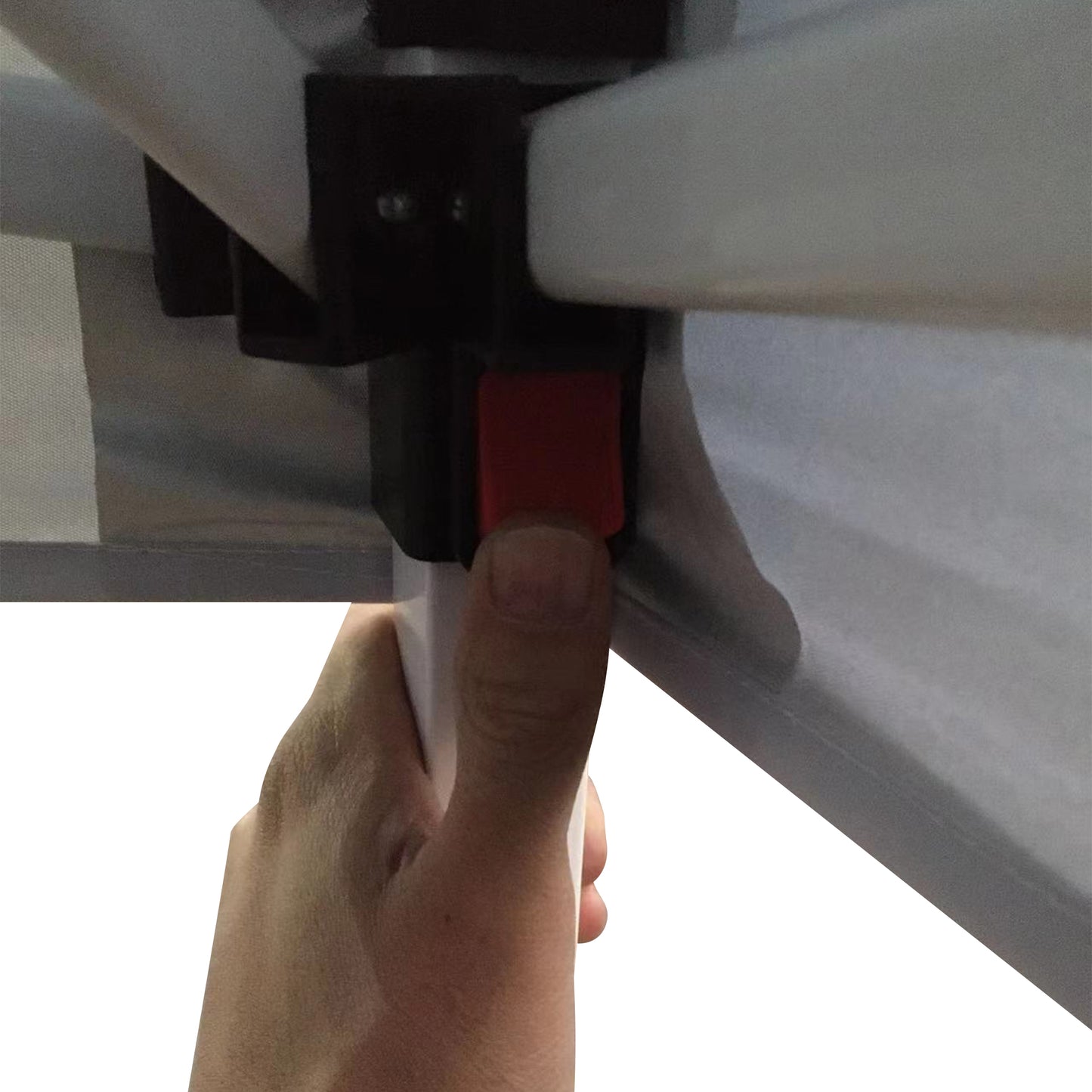 Closeup of a hand pressing a red button on a white tent frame mechanism