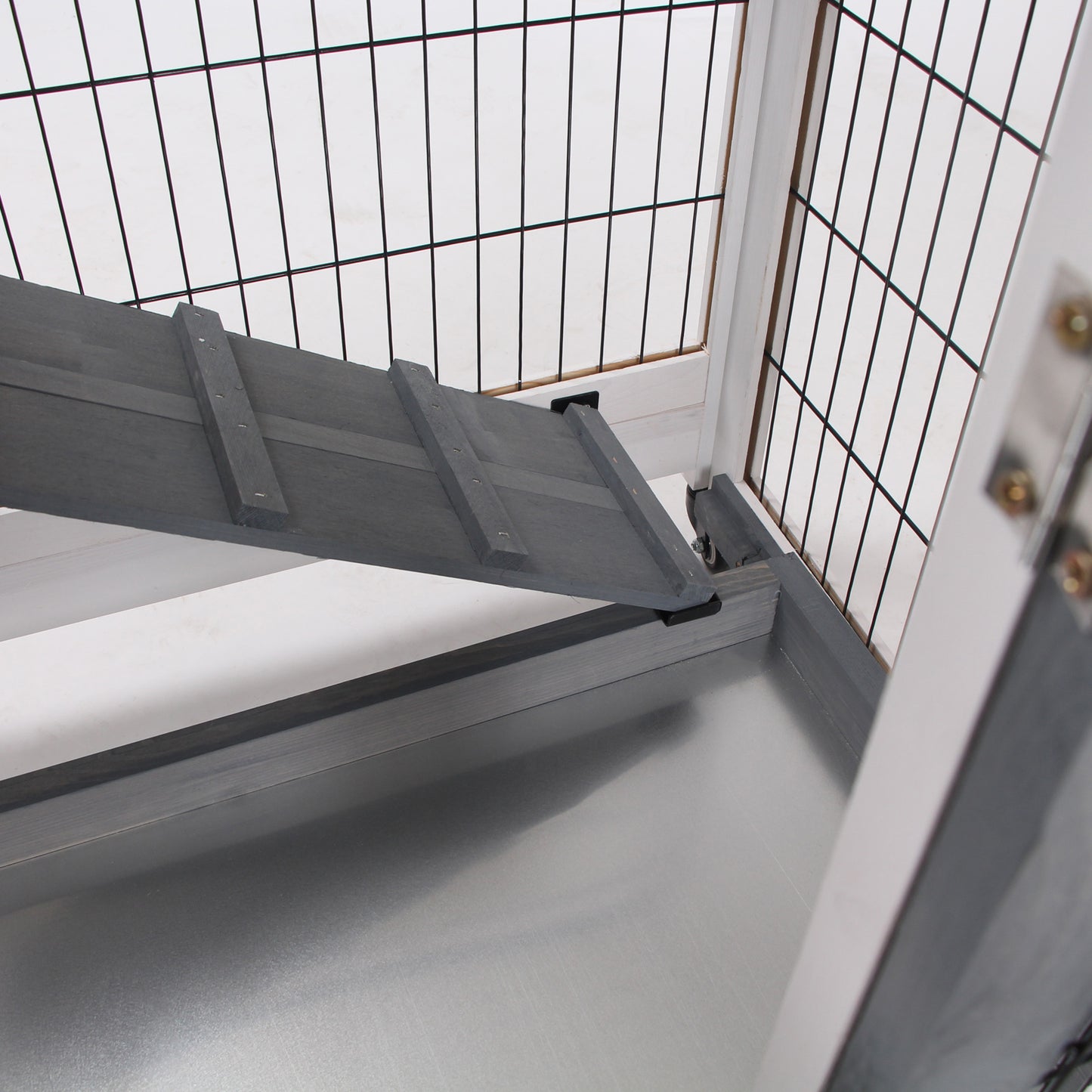 Grey wooden ramp with textured surface inside a pet cage Primary keyword pet cage