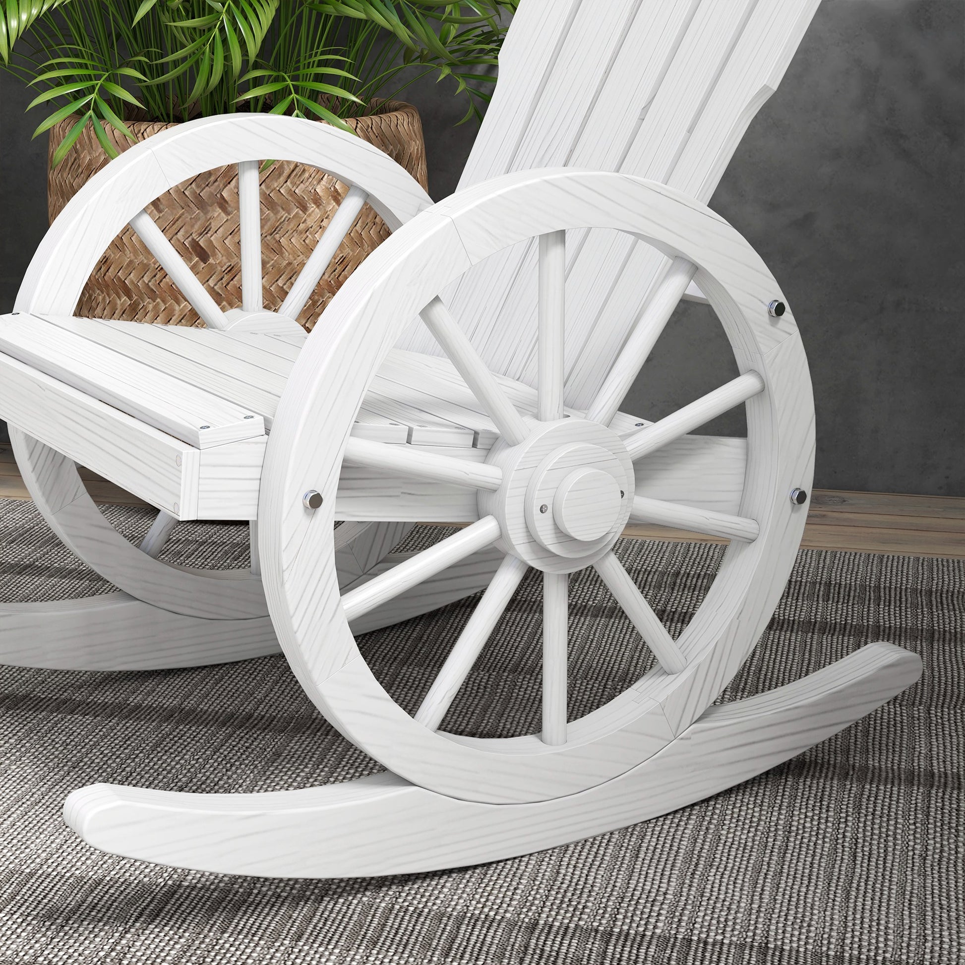 White wooden wagon wheel rocking chair with a rustic design and comfortable seating