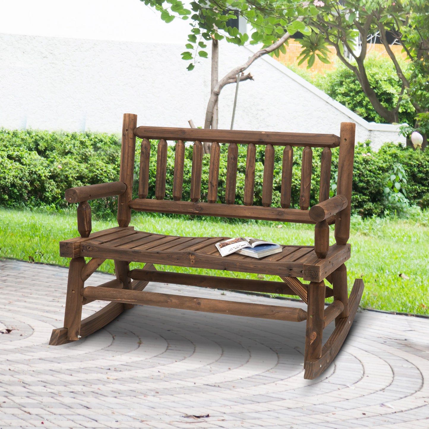 Rustic wooden outdoor rocking bench with a book on seat