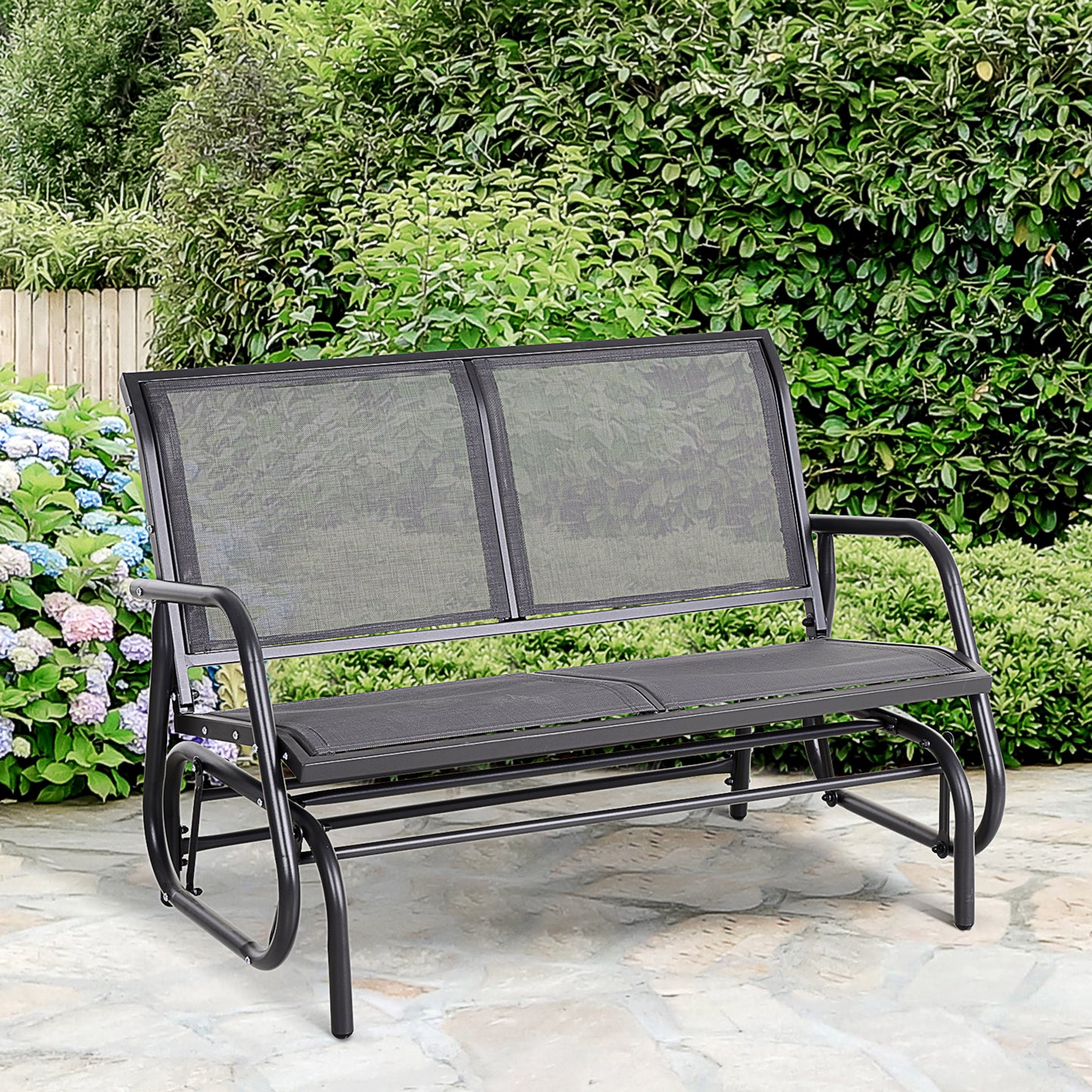 Black mesh twoseater outdoor glider bench with curved arms and a metal frame on a stone patio