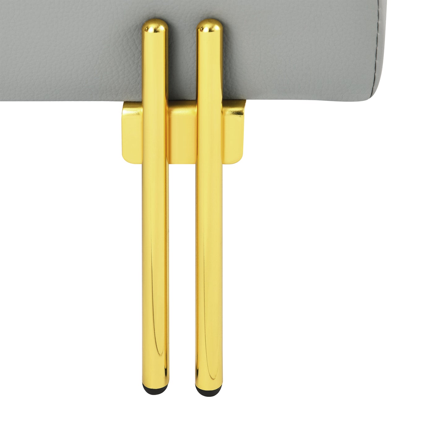 Close up of grey faux leather upholstery on a stool with sleek gold legs