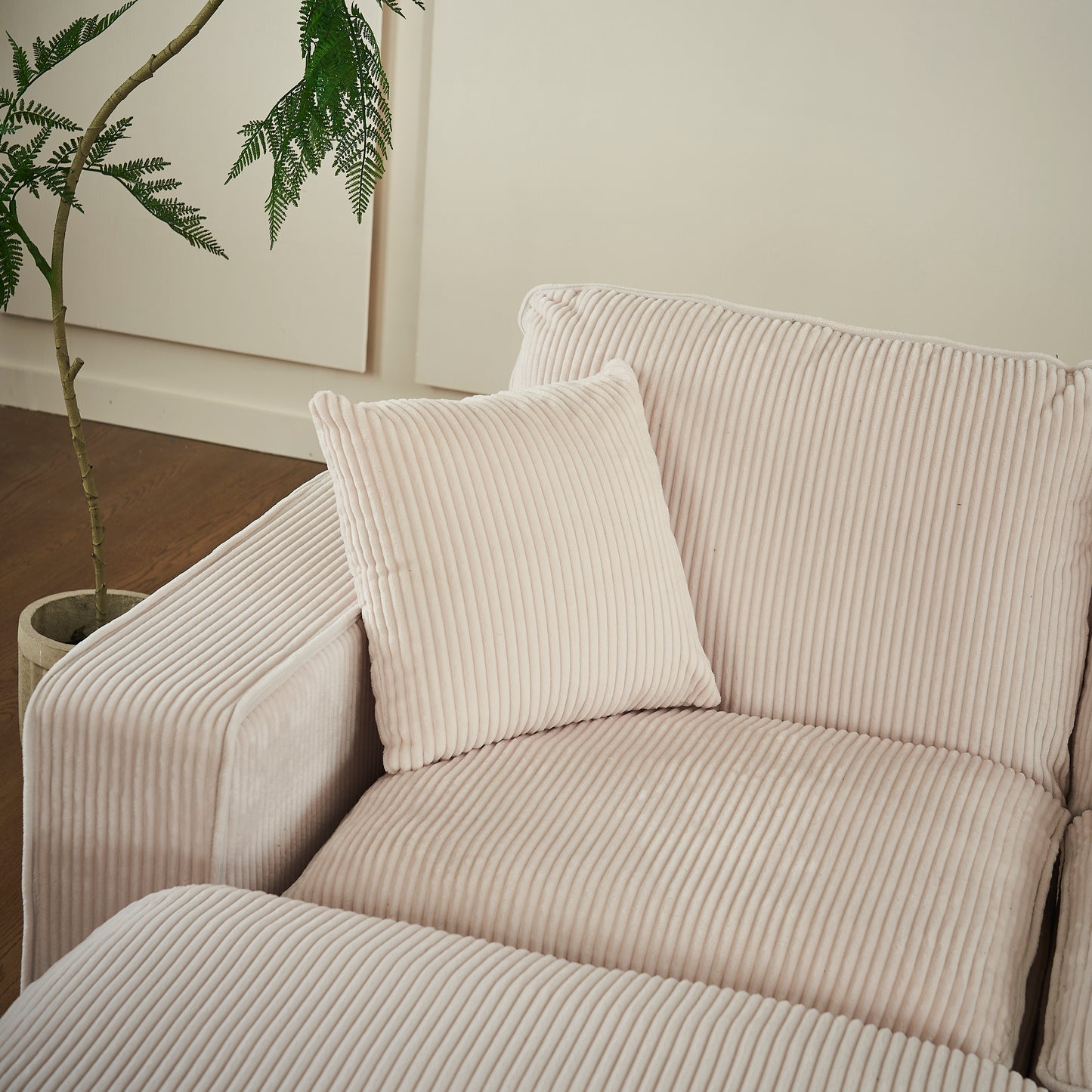 Plush corduroy cream sofa with textured cushions perfect for a cozy living room