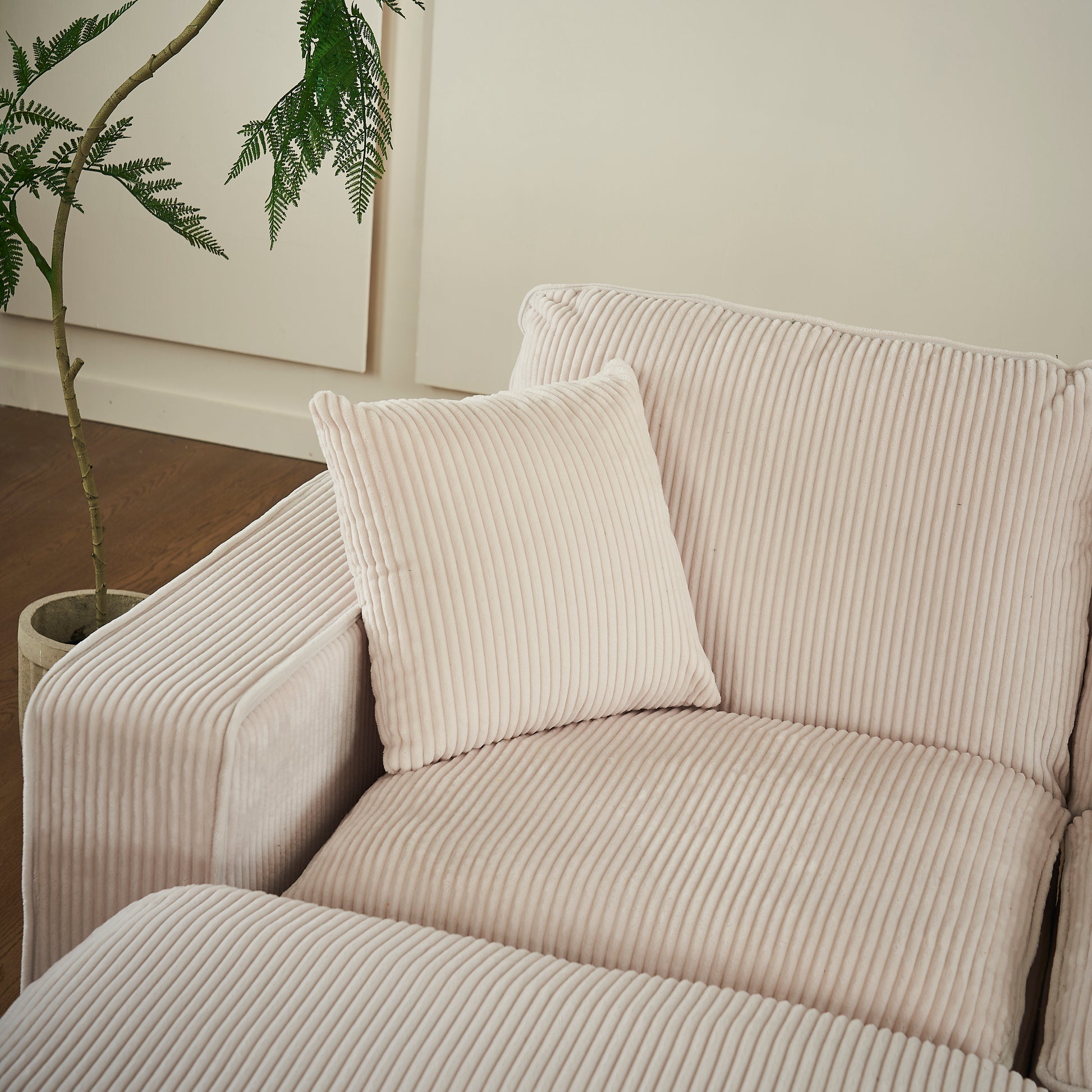 Plush corduroy cream sofa with textured cushions perfect for a cozy living room