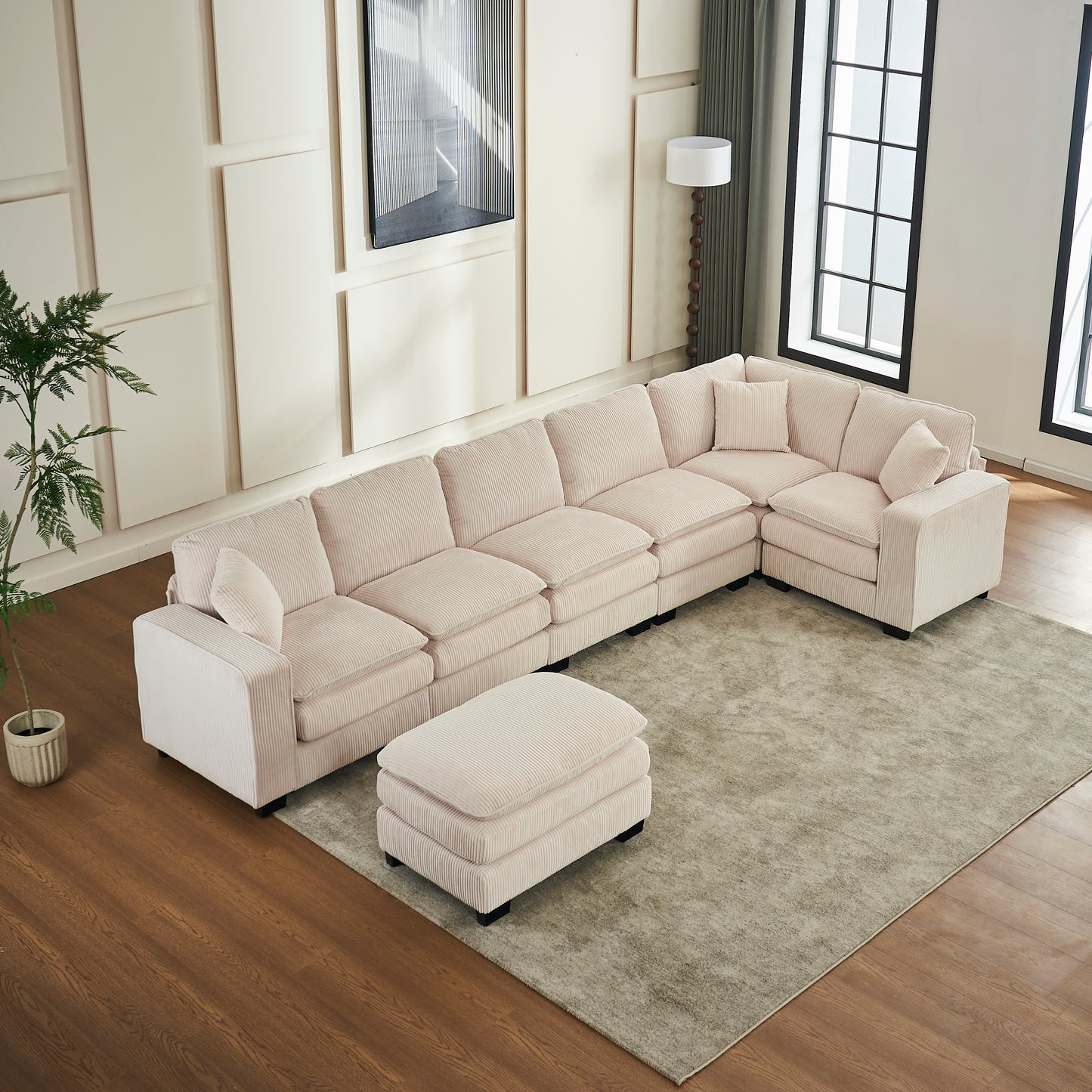 Light pink corduroy sectional sofa with matching ottoman and accent pillows