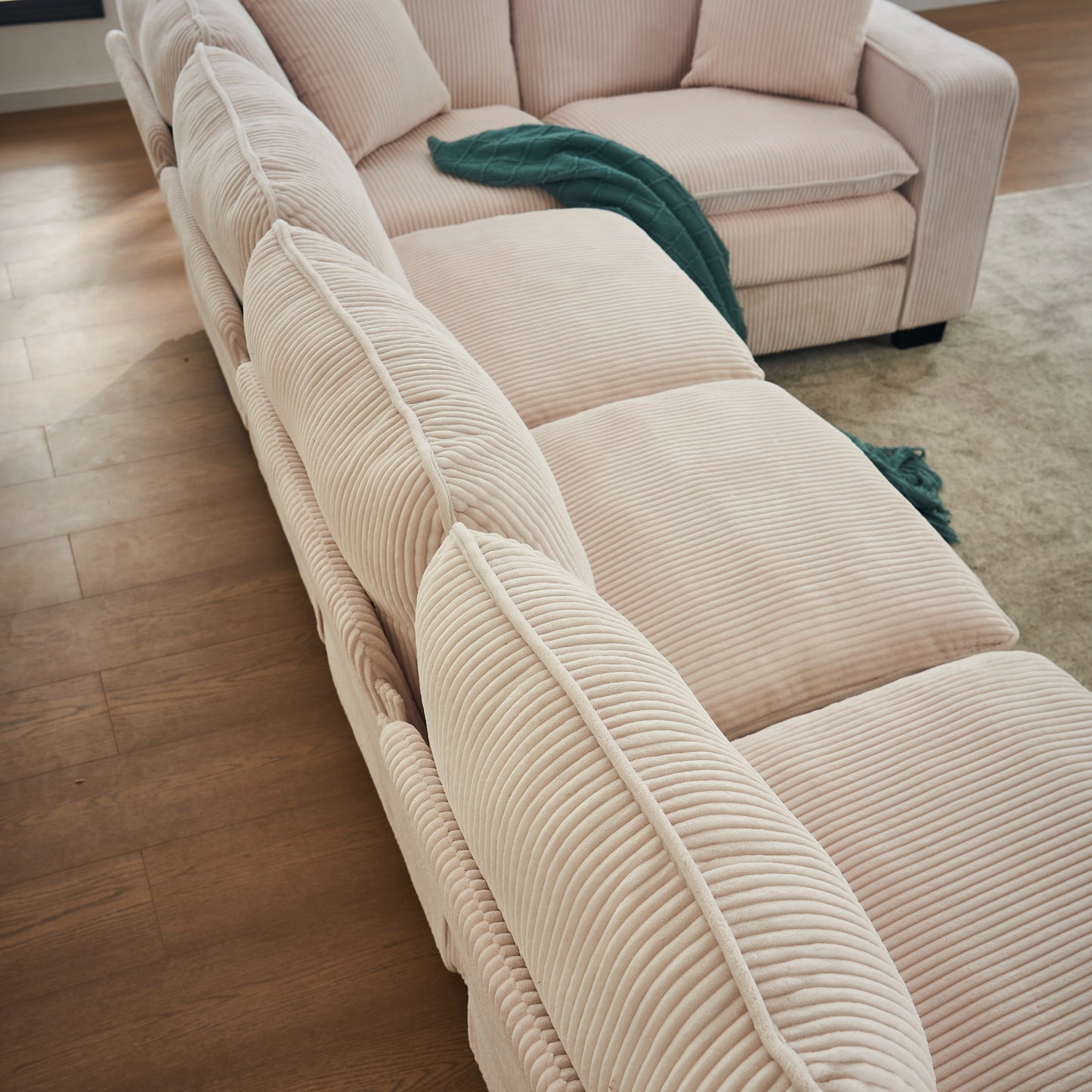 Plush cream corduroy sectional sofa with wide channeltufted cushions