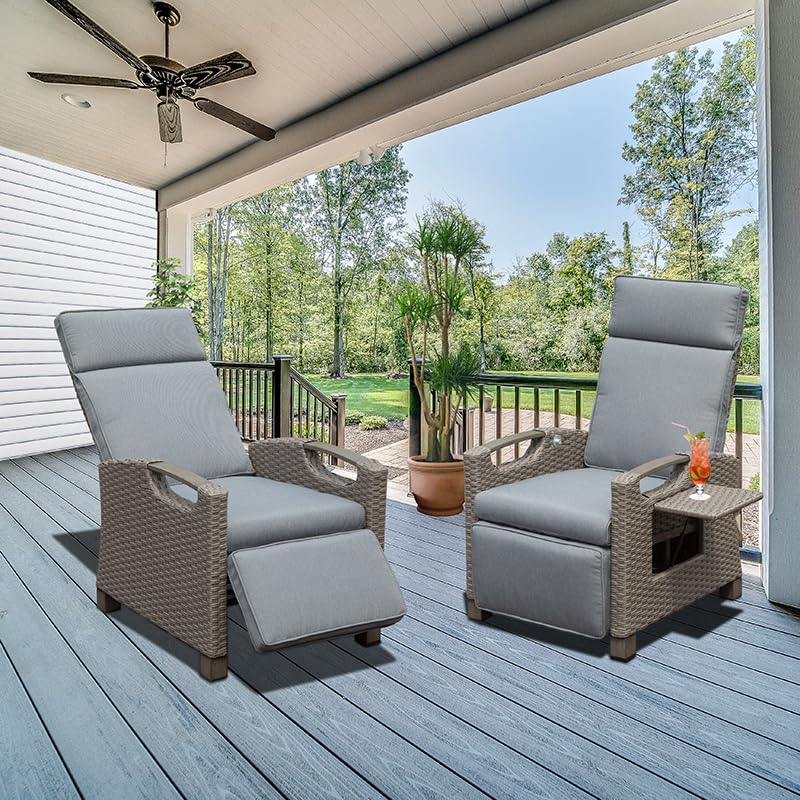 Two grey wicker outdoor recliners with plush cushions on a blue deck