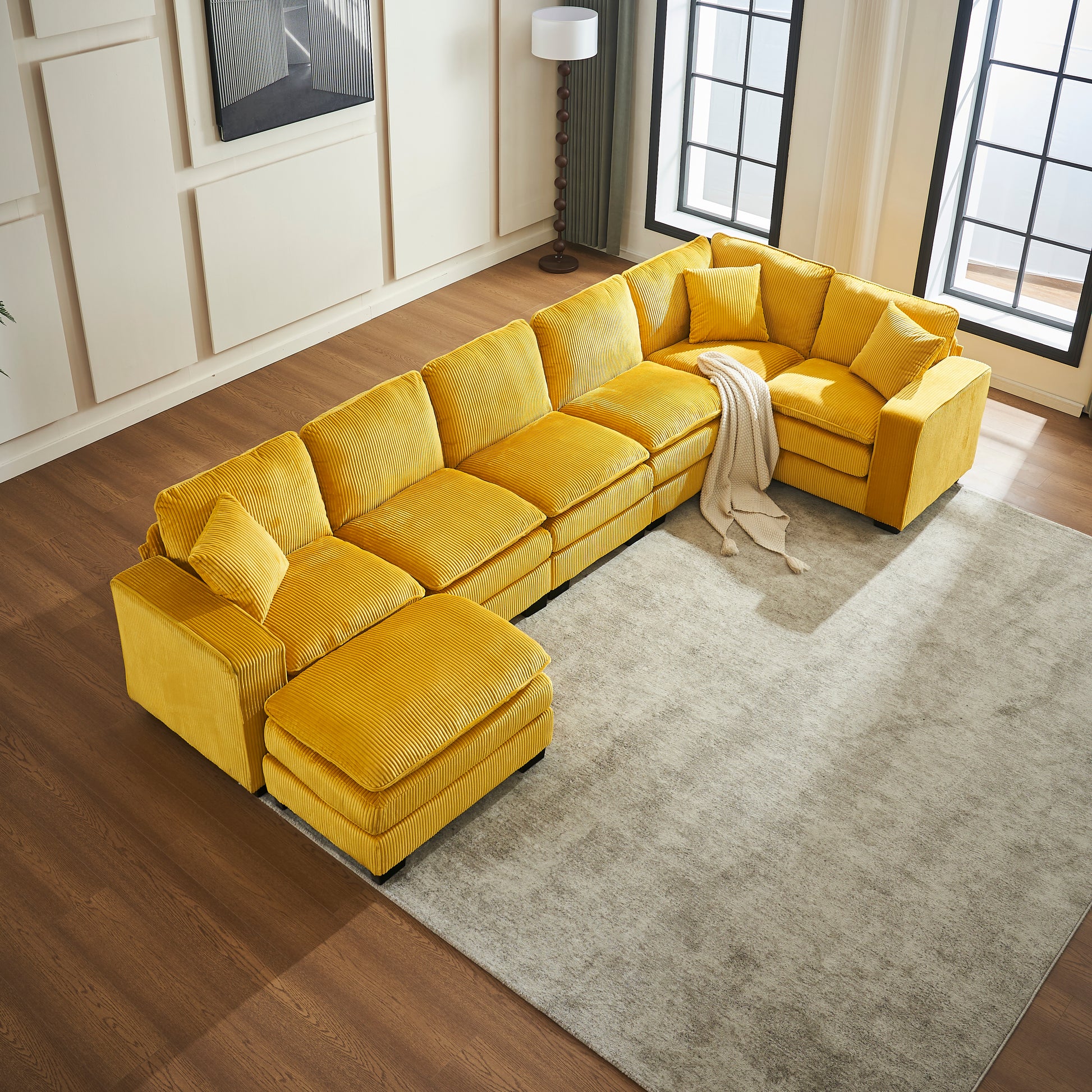 Bright yellow corduroy sectional sofa with ottoman and plush cushions perfect for modern living rooms