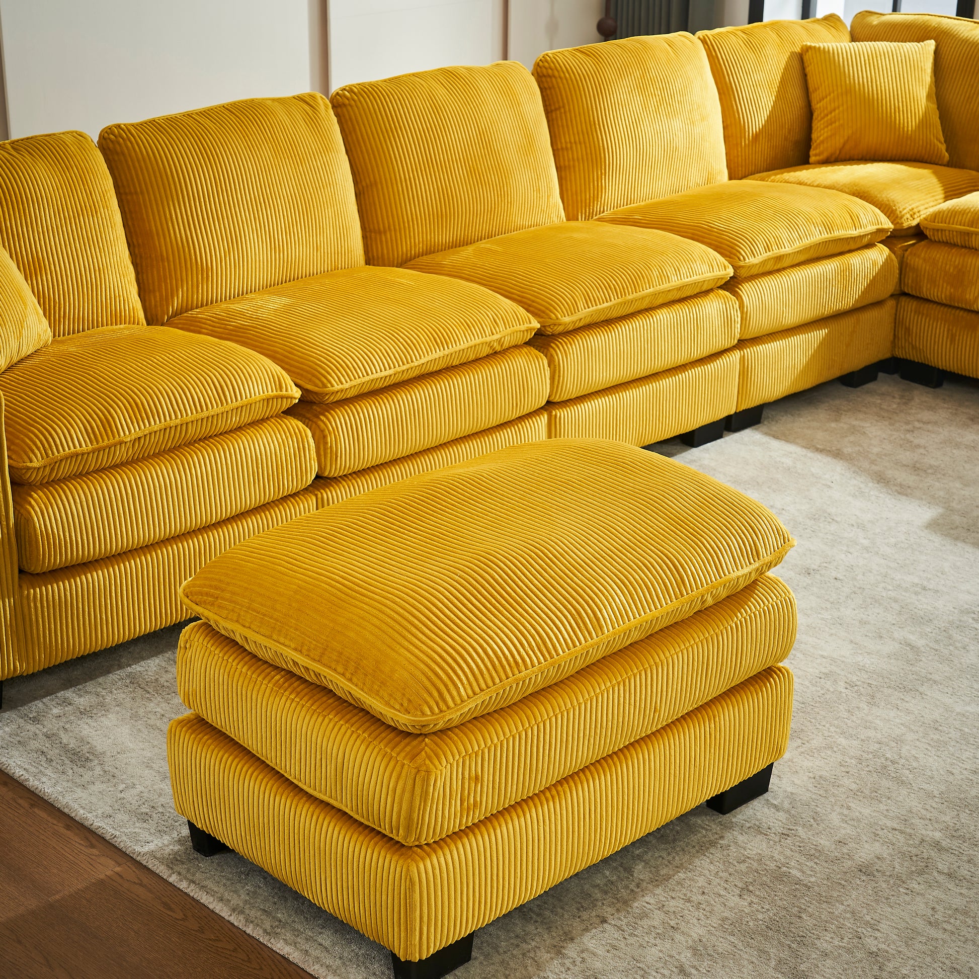Plush yellow corduroy sectional sofa with deep seats and modern black legs