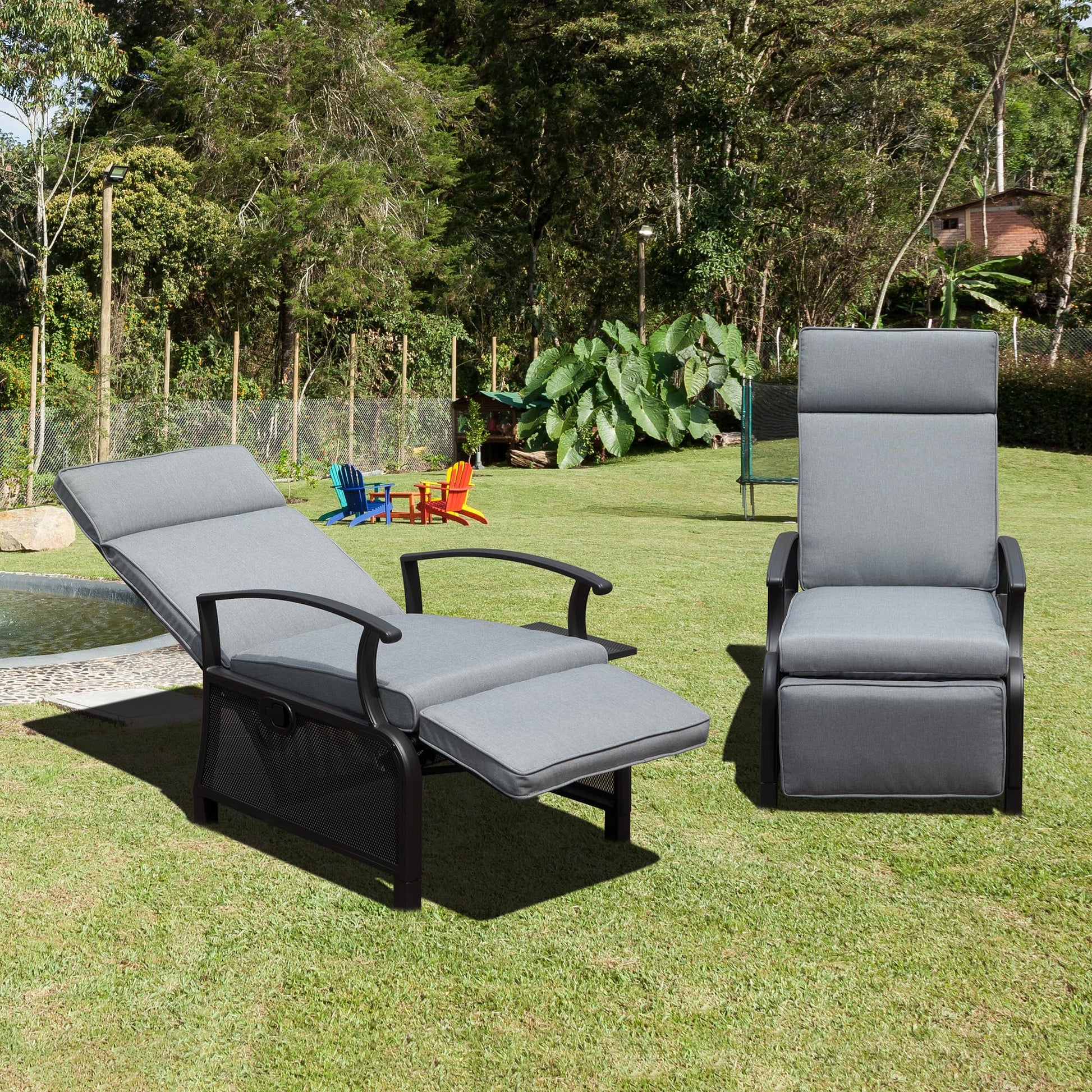 Gray recliner patio chair with adjustable footrest on lush green grass