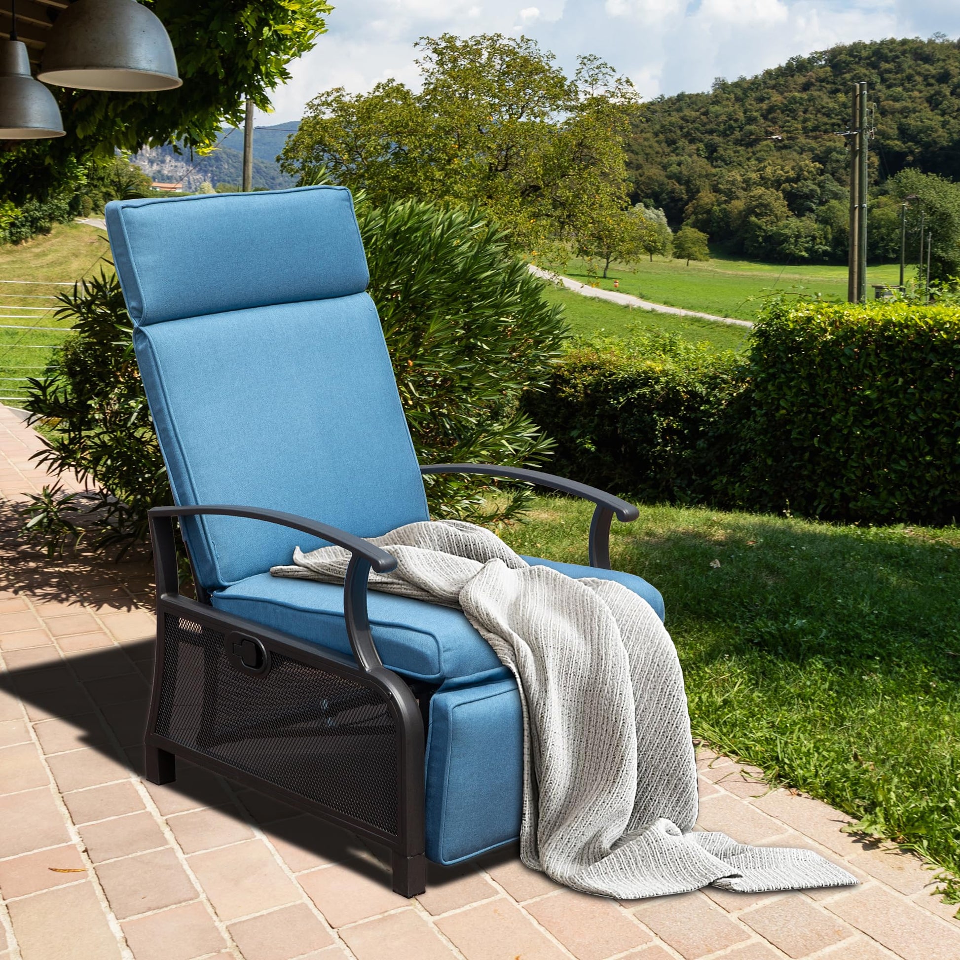 Blue upholstered recliner with metal frame and mesh accents draped with a knitted throw