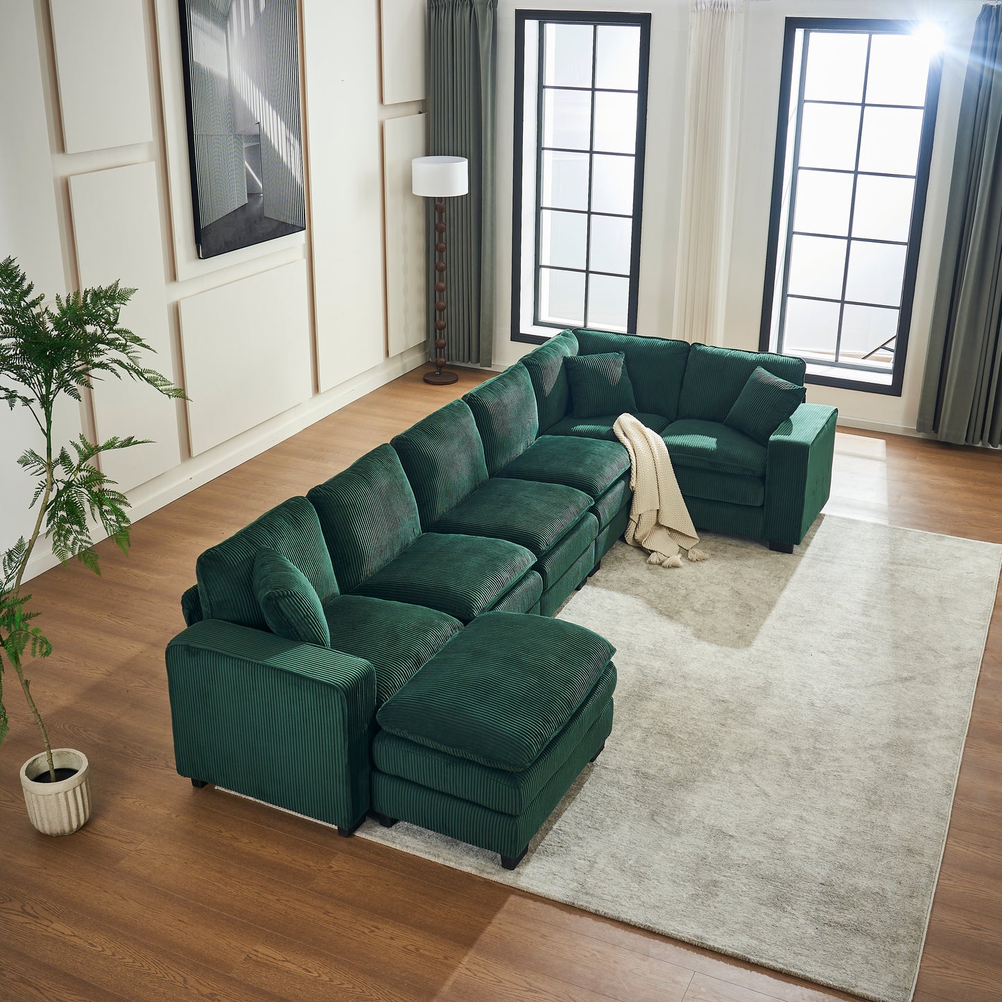 Deep green corduroy sectional sofa with chaise and ottoman