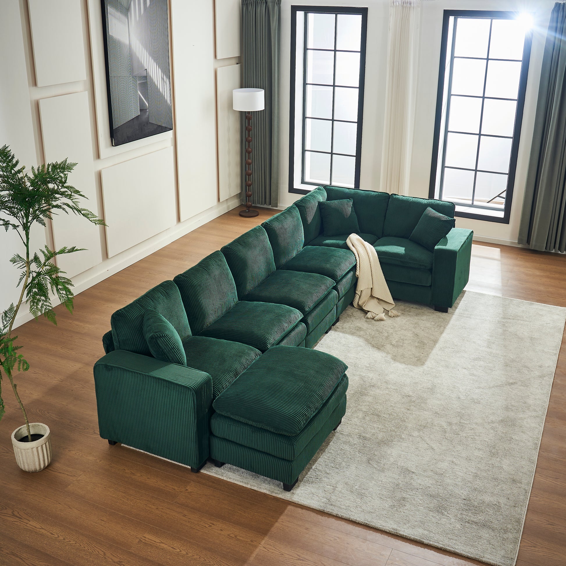 Deep green corduroy sectional sofa with chaise and ottoman