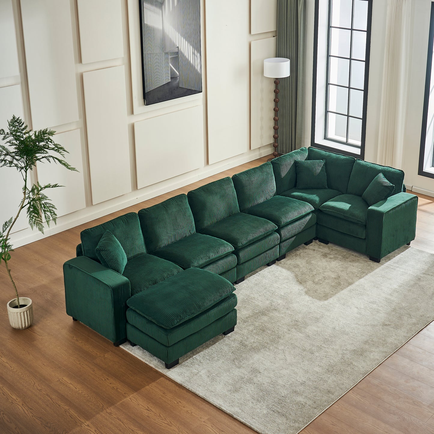 Emerald green corduroy sectional sofa with plush cushions and a chaise lounge perfect for modern living rooms