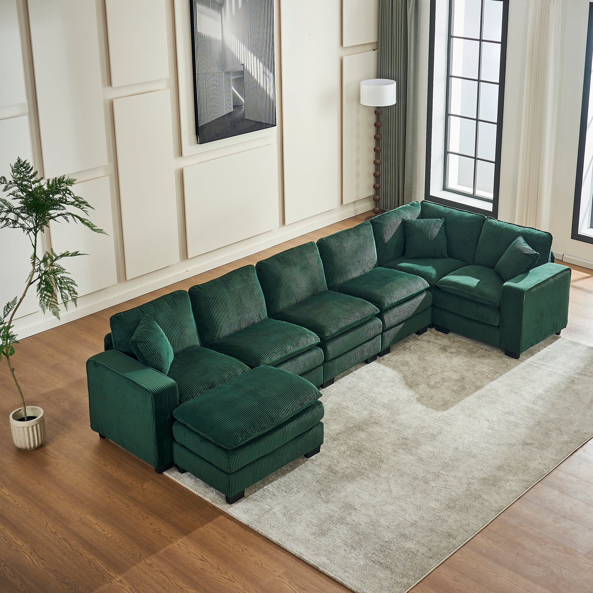 Emerald green corduroy sectional sofa with plush cushions and a chaise lounge perfect for modern living rooms