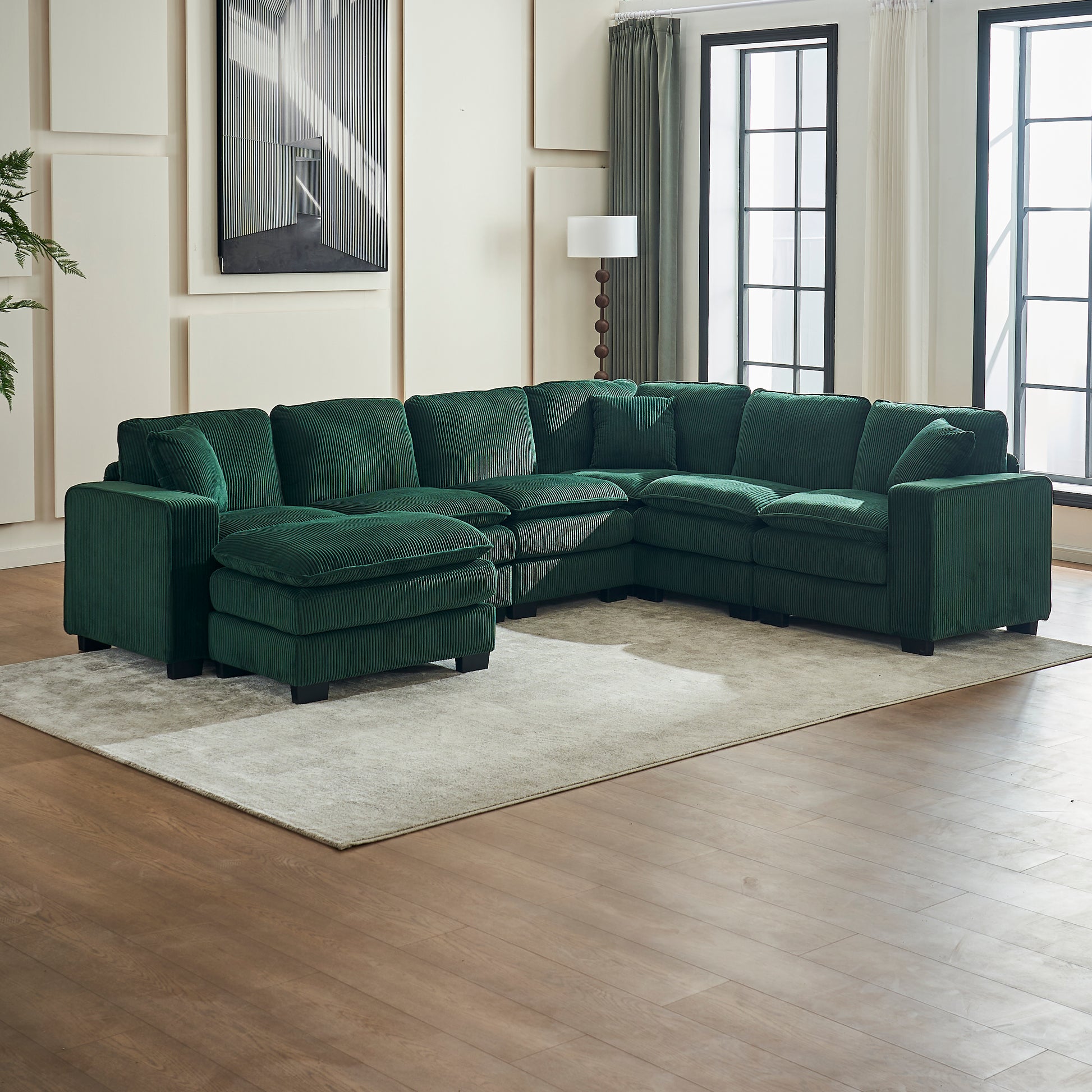 Emerald green corduroy sectional sofa with ottoman perfect for a modern living room