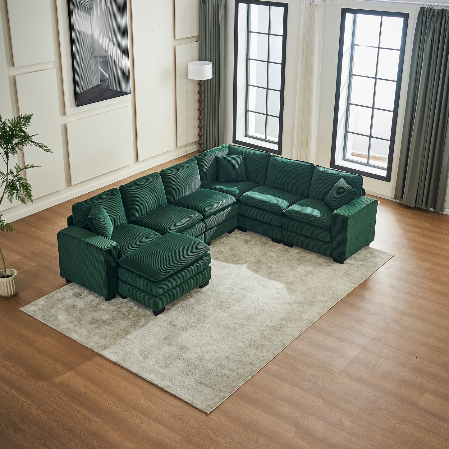 Deep emerald green corduroy sectional sofa with movable ottoman perfect for modern living rooms