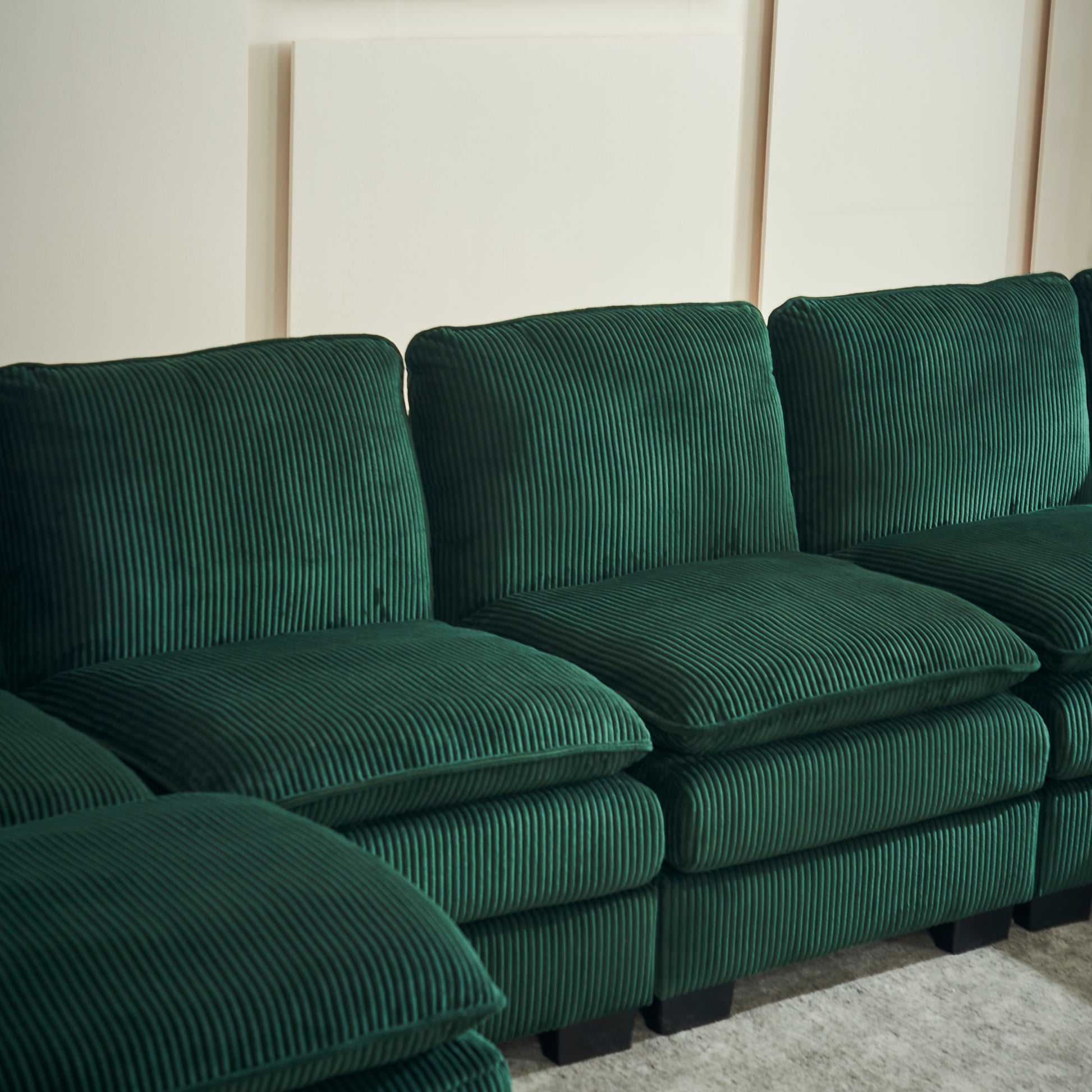 Deep green corduroy sectional sofa with plush cushions and a modern design ideal for living rooms