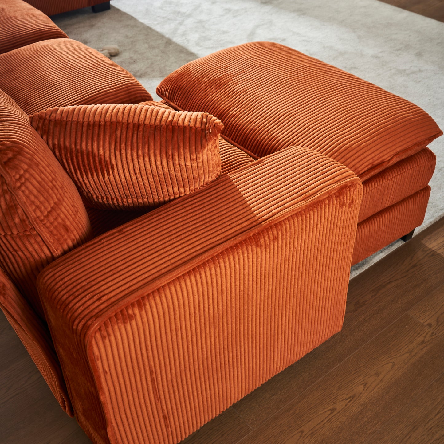 Plush orange corduroy sofa sectional with deep textured cushions for cozy living room comfort