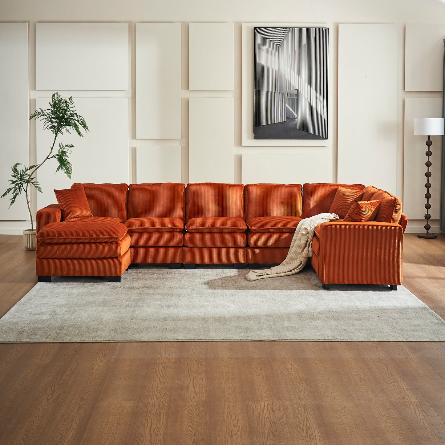 Plush orange corduroy sectional sofa with Ushaped configuration and accent pillows for a cozy living room