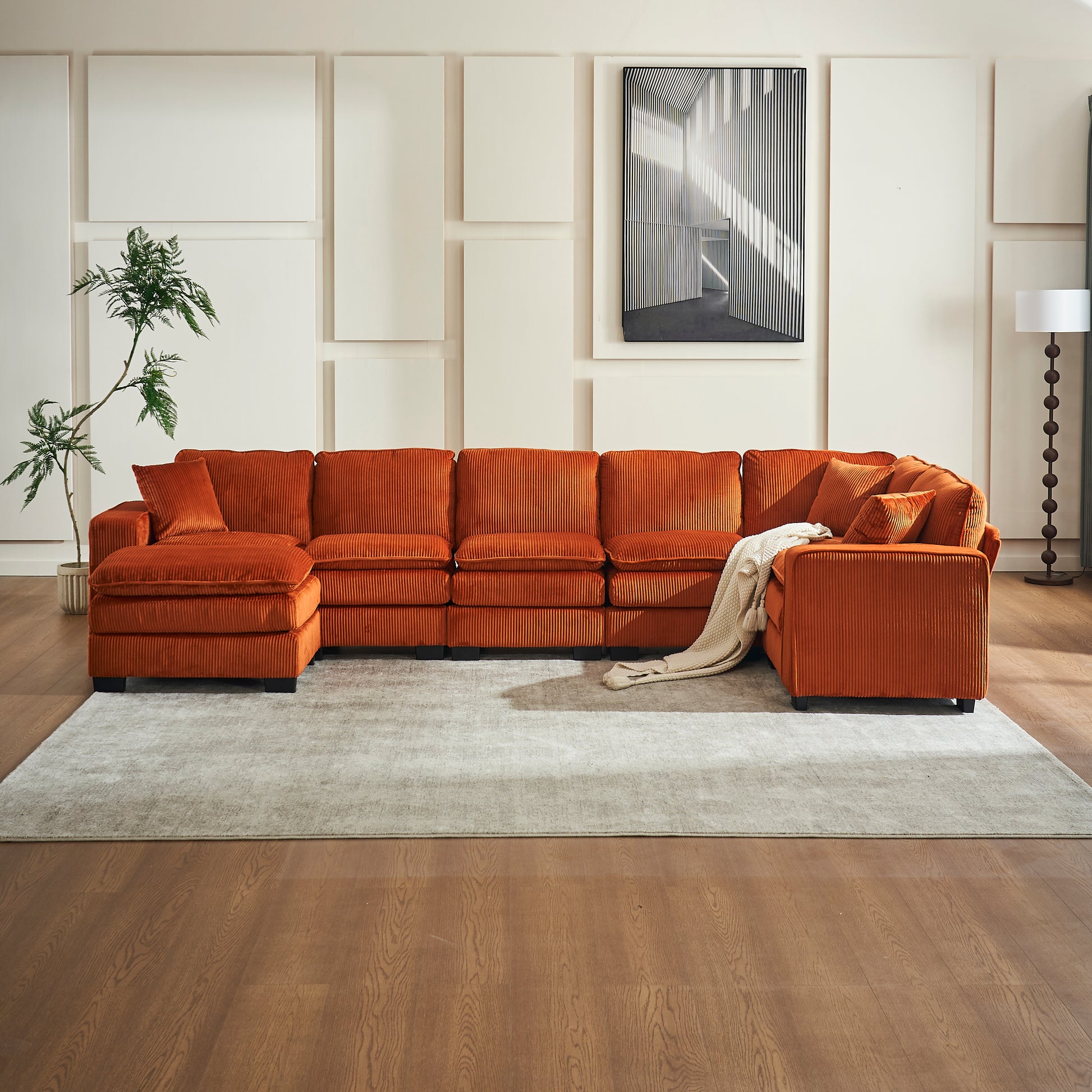 Plush orange corduroy sectional sofa with Ushaped configuration and accent pillows for a cozy living room